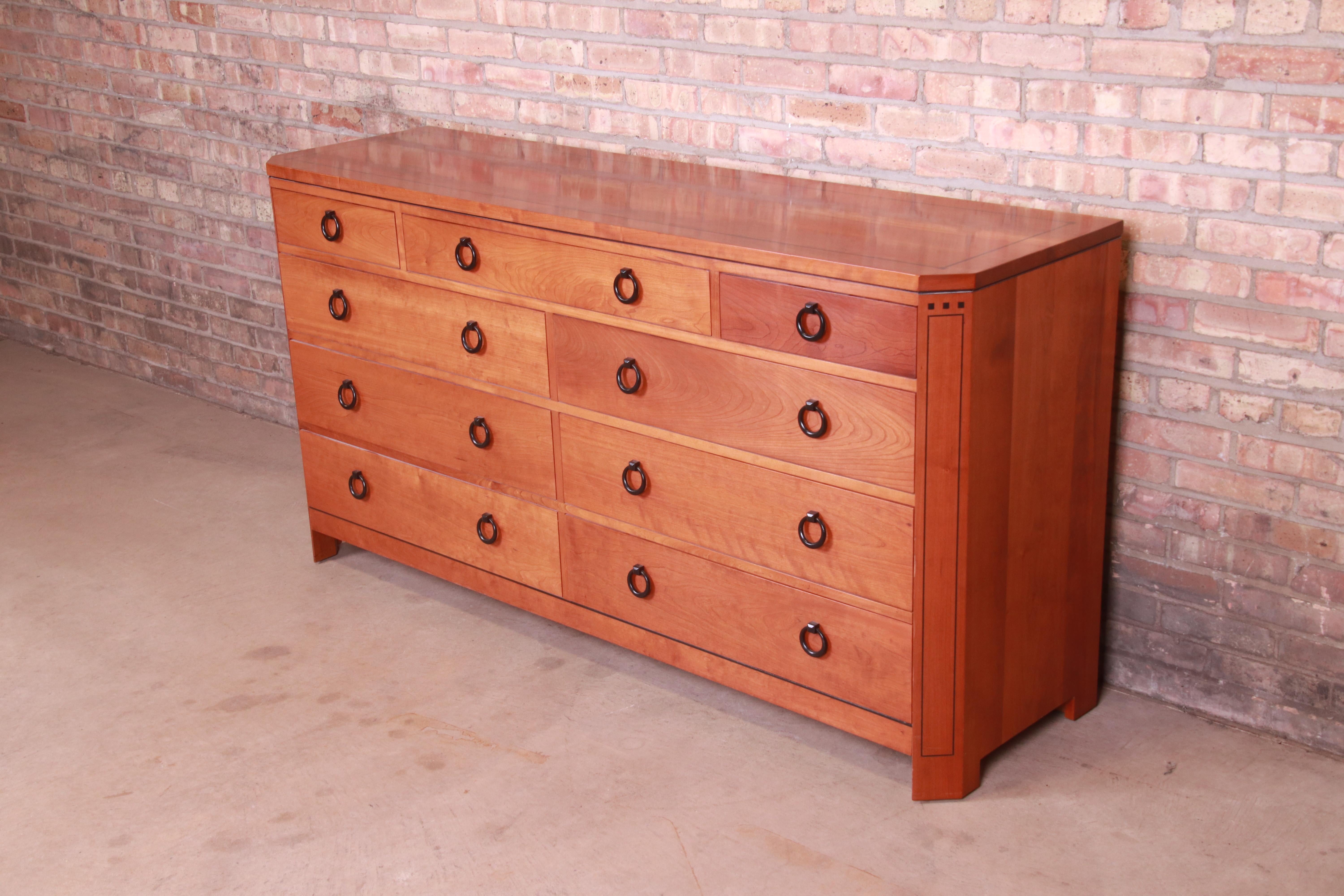 A gorgeous Arts & Crafts style nine-drawer dresser or credenza

By L. & J.G. Stickley

USA, Circa 2000

Solid cherry wood, with inlaid ebonized details and original hardware.

Measures: 68.5