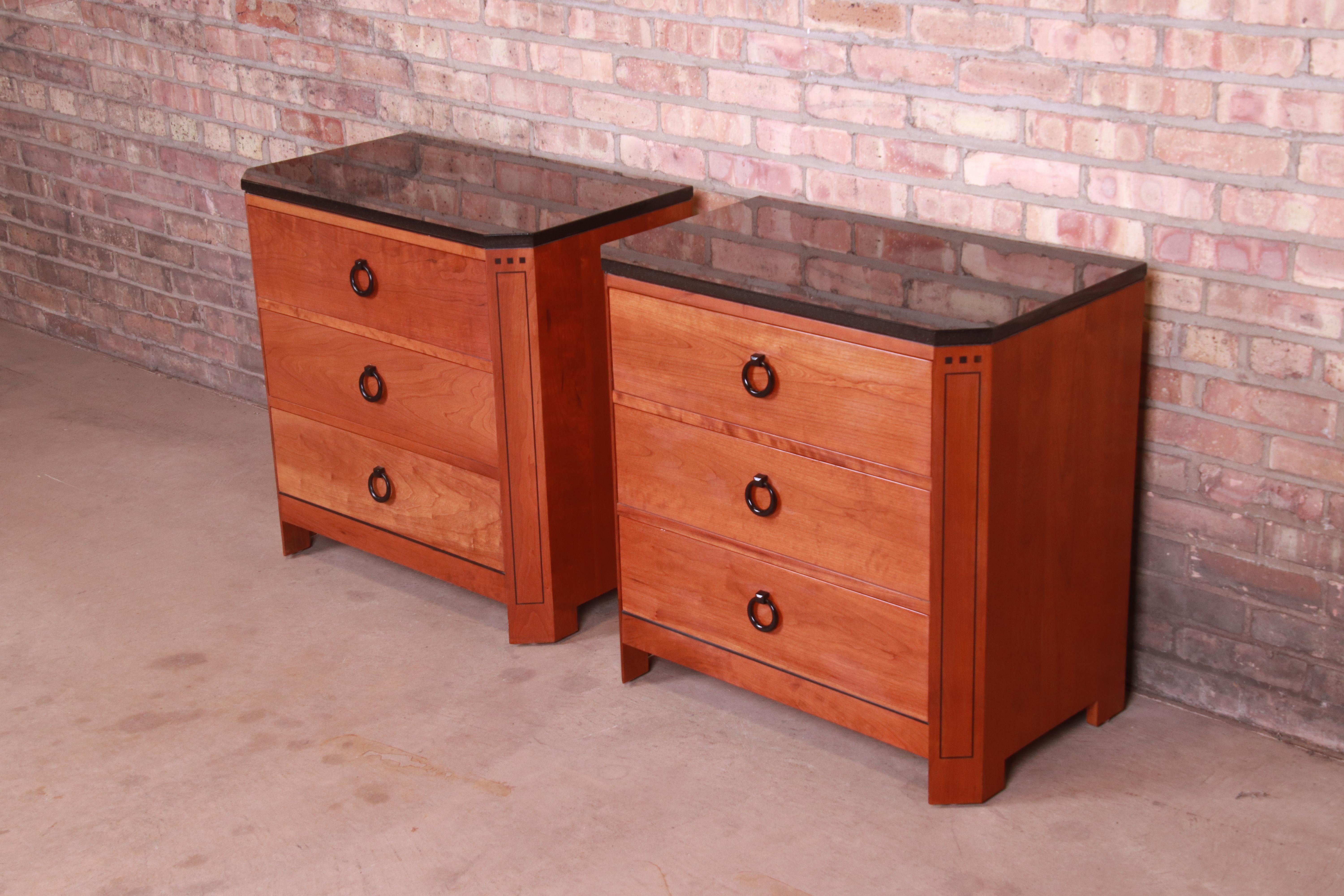 A gorgeous pair of Arts & Crafts style nightstands

By L. & J.G. Stickley

USA, Circa 2000

Solid cherry wood, with ebonized inlaid details and granite tops.

Measures: 28