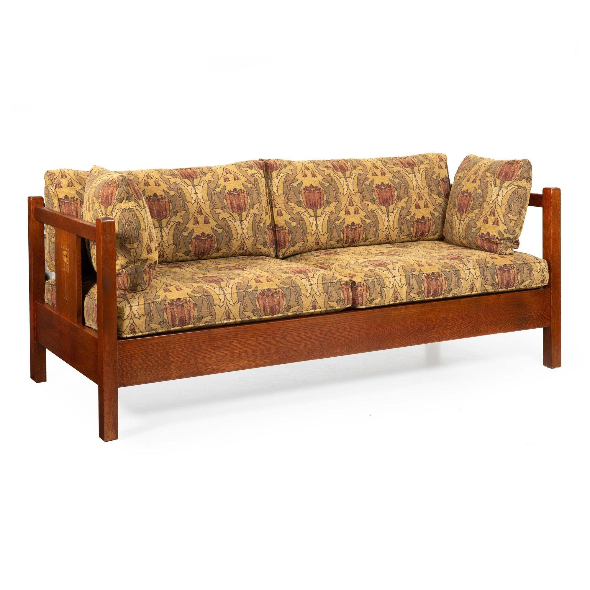 A very finely crafted and beautifully inlaid solid oak sofa by Stickley from their Harvey Ellis Collection, it retains the original upholstery which overall appears almost to be unused. The oak retains a gorgeous overall glow and the surface is