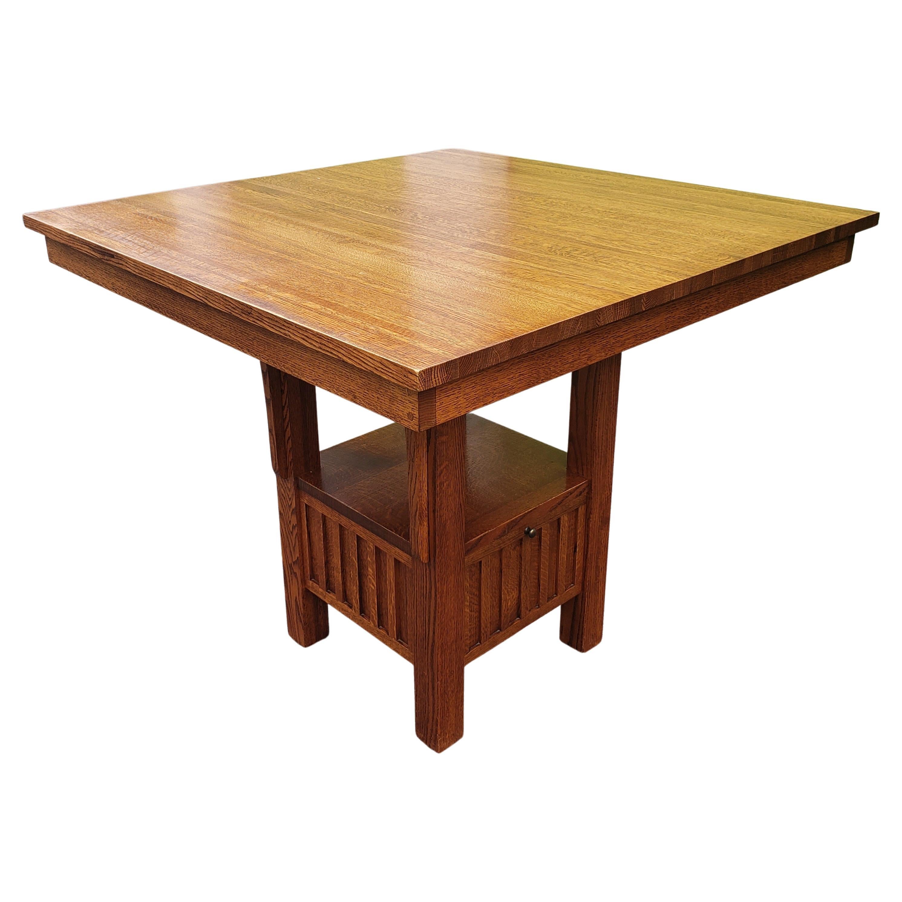 Stickley attributed Quarter sawn mission oak high top dining table. 
Table features a bottom large drawer for storage. Comes with custom protective pad.
Measures 42 inches wide, 42 inches in depth and stands 36.5 inches tall. Table to[ is 1inches