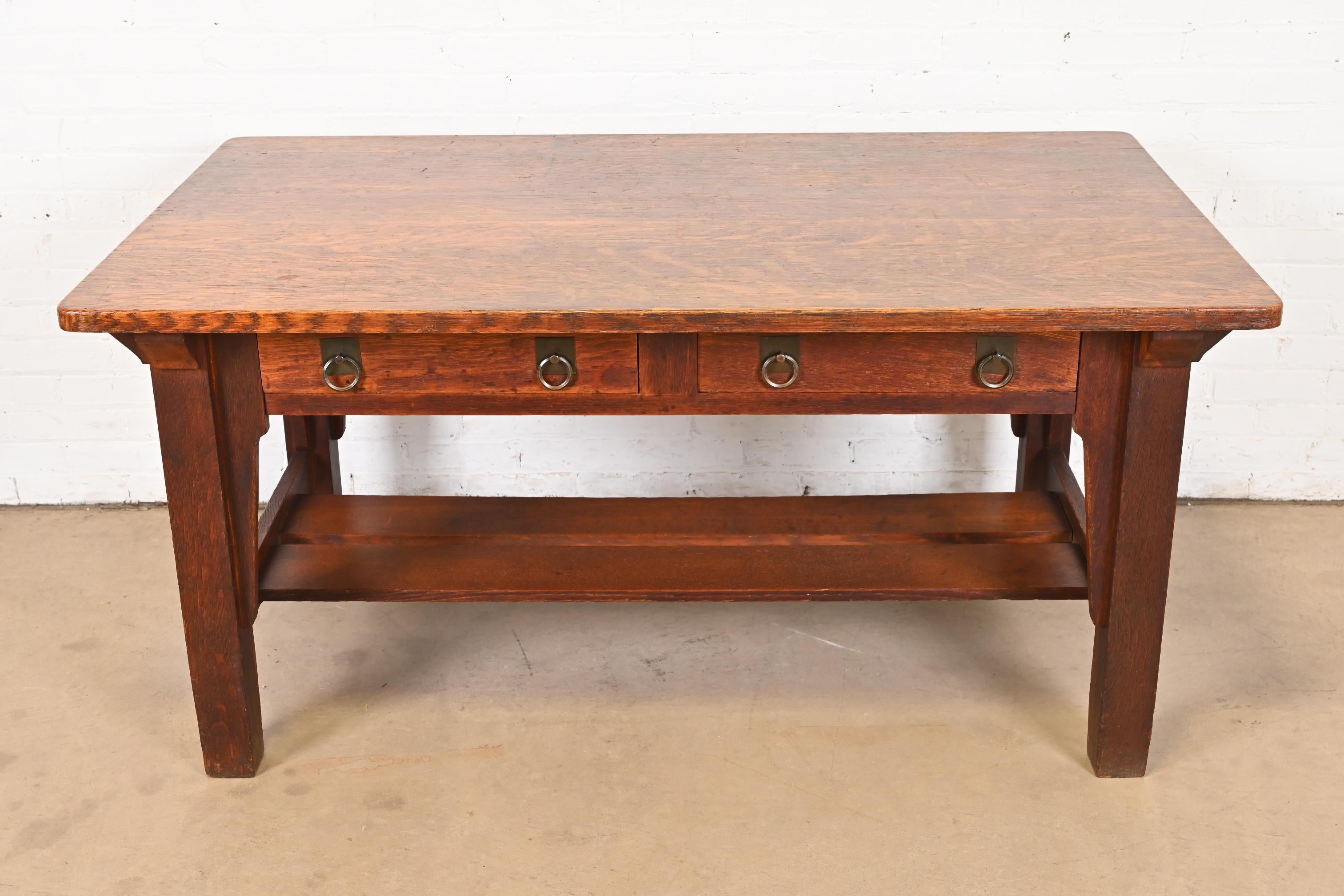 An exceptional antique Mission or Arts & Crafts writing desk or library table

By Stickley Brothers

USA, Circa 1900

Quarter sawn oak, with original copper hardware.

Measures: 60