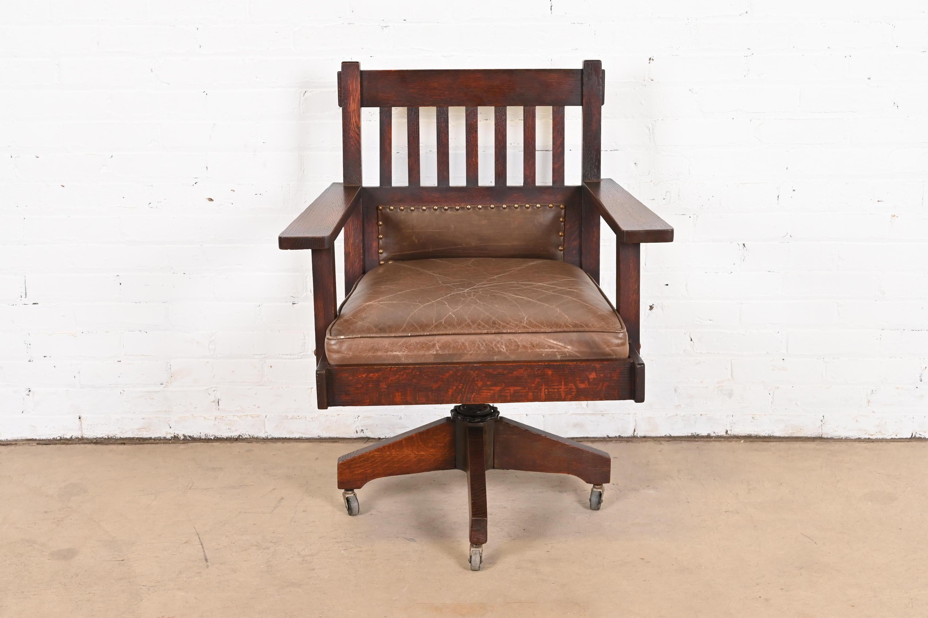 A rare and exceptional Mission or Arts & Crafts executive swivel desk chair

By Stickley Brothers

USA, circa 1900

Solid quarter sawn oak and iron frame, with brown leather upholstery.

Measures: 29