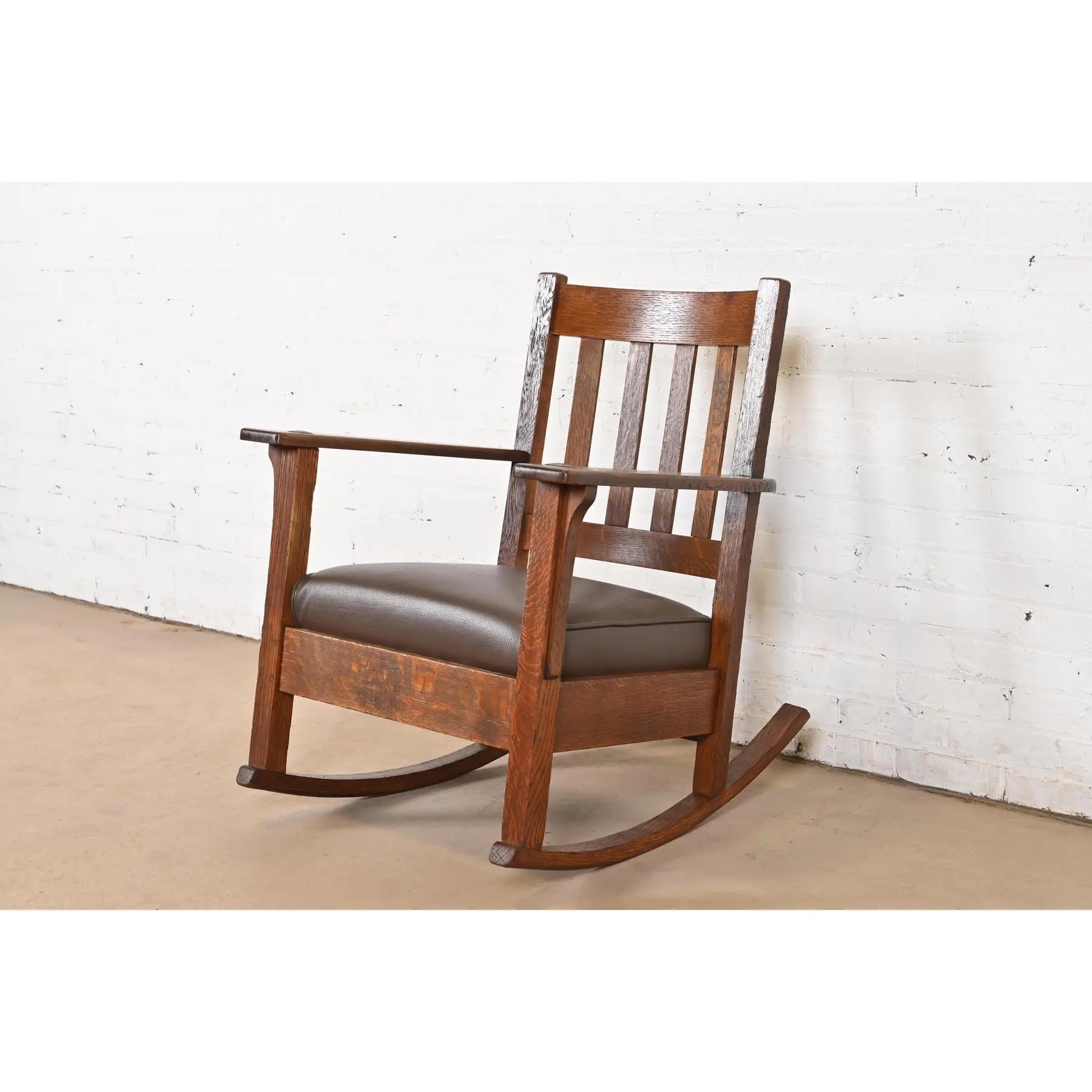 A gorgeous antique Mission or Arts & Crafts period rocking chair

By Stickley Brothers

USA, Circa 1910

Solid quarter sawn oak frame, with brown leather seat cushion.

Measures: 27.38