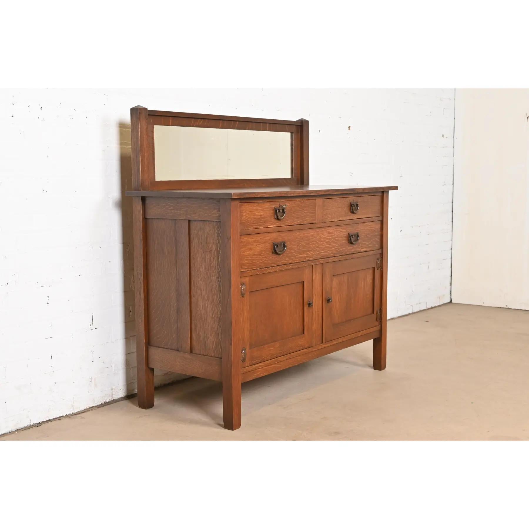 A gorgeous antique Mission or Arts & Crafts period sideboard, buffet server, or bar cabinet

By Stickley Brothers

USA, Circa 1900

Quarter sawn oak, with mirrored backsplash, and original hammered copper hardware.

Measures: 50