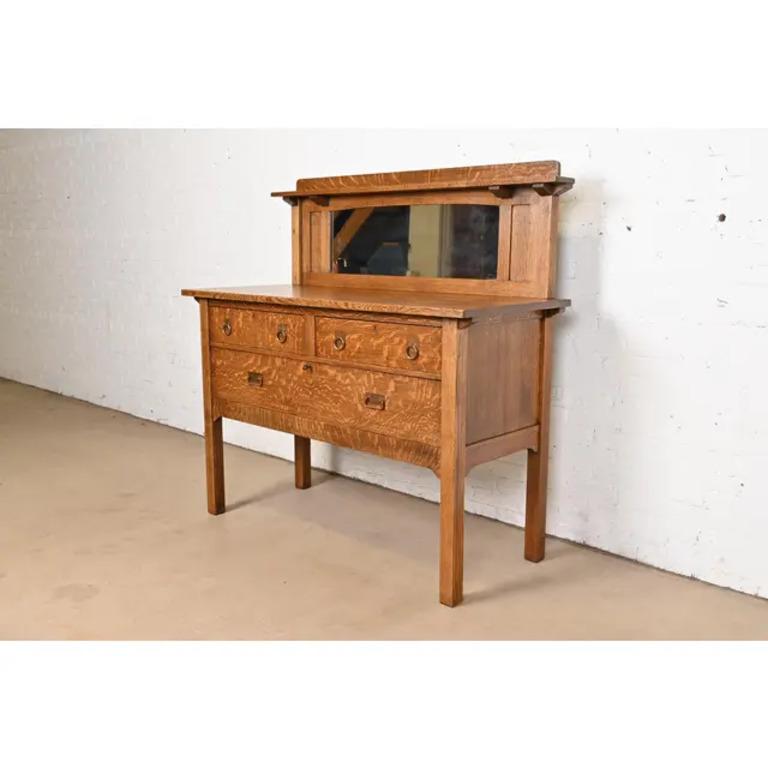 A gorgeous antique Mission or Arts & Crafts period sideboard, buffet server, or bar cabinet

By Stickley Brothers

USA, Circa 1900

Gorgeous quarter sawn tiger oak, with mirrored backsplash, and original hammered copper hardware. Drawers lock, and