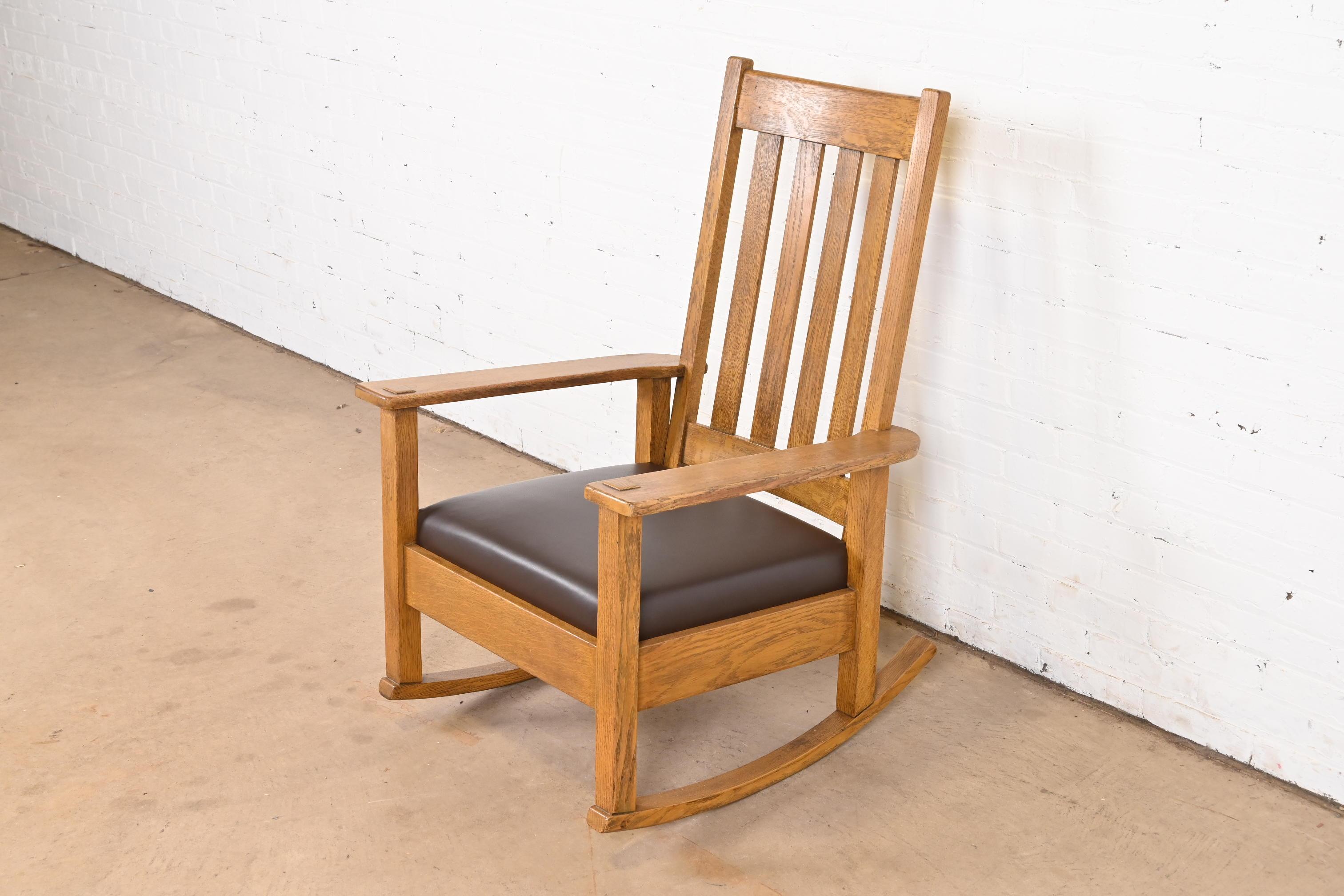 An exceptional Mission or Arts & Crafts period rocking chair

By Stickley Brothers

USA, Circa 1900

Solid quarter sawn oak, with brown leather upholstery.

Measures: 27.5