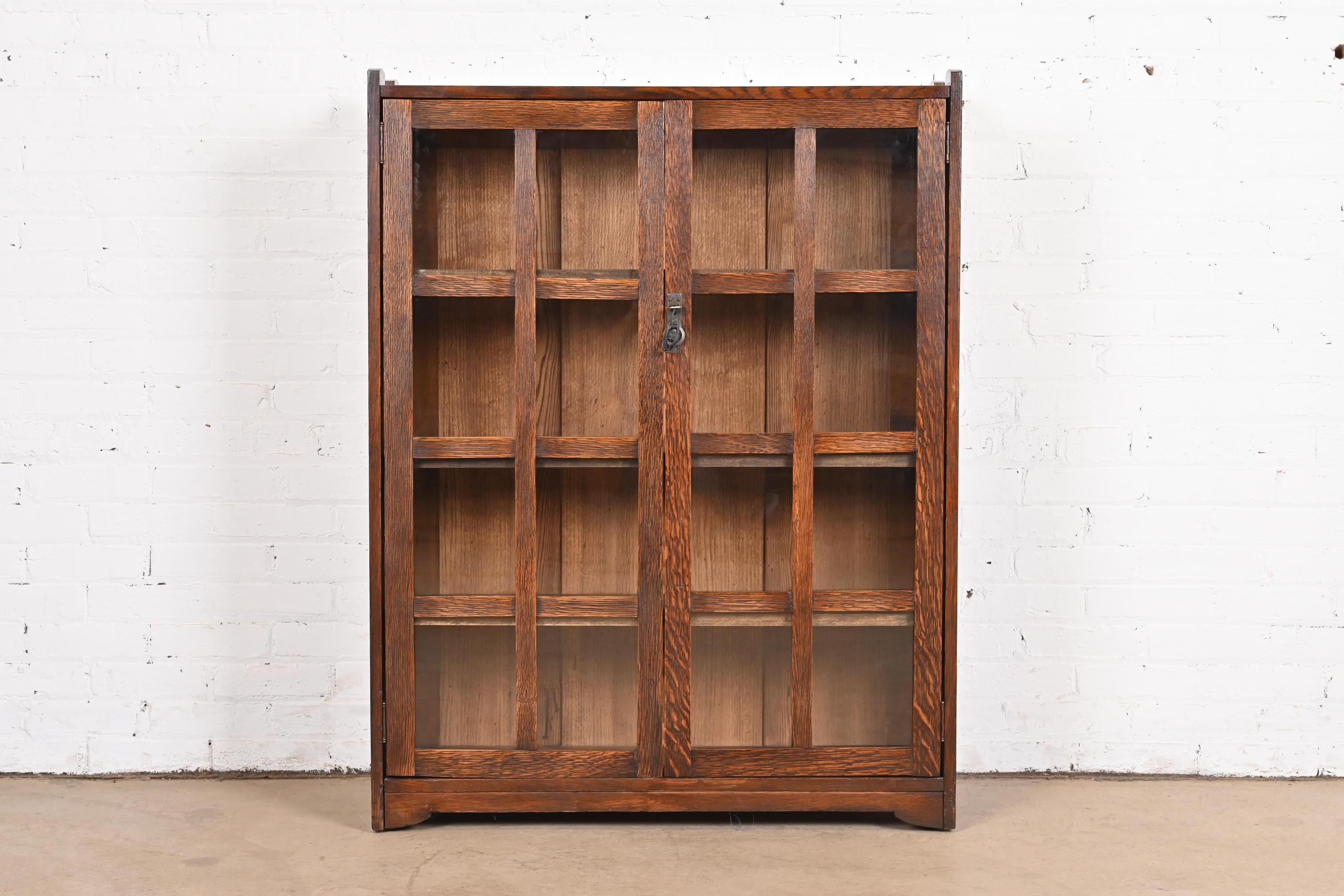 A gorgeous antique Mission or Arts & Crafts bookcase cabinet

By Stickley Brothers

USA, Circa 1900

Quarter sawn oak, with mullioned glass front doors, and original copper hardware. Cabinet locks, and key is included.

Measures: 35.75