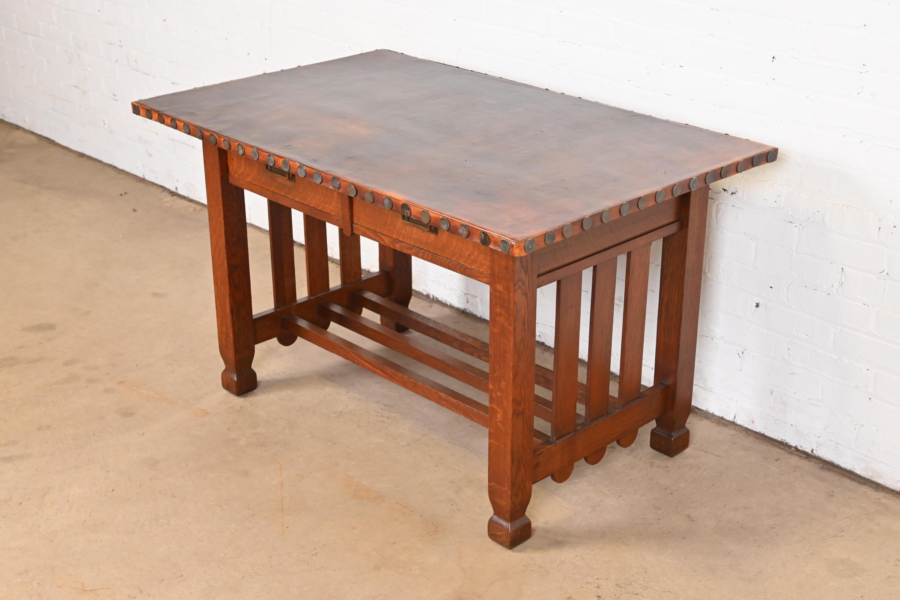 A rare and exceptional antique Mission oak Arts & Crafts writing desk or library table

By Stickley Brothers

USA, Circa 1900

Solid quarter sawn oak, with original leather top, and hammered copper hardware.

Measures: 48.5
