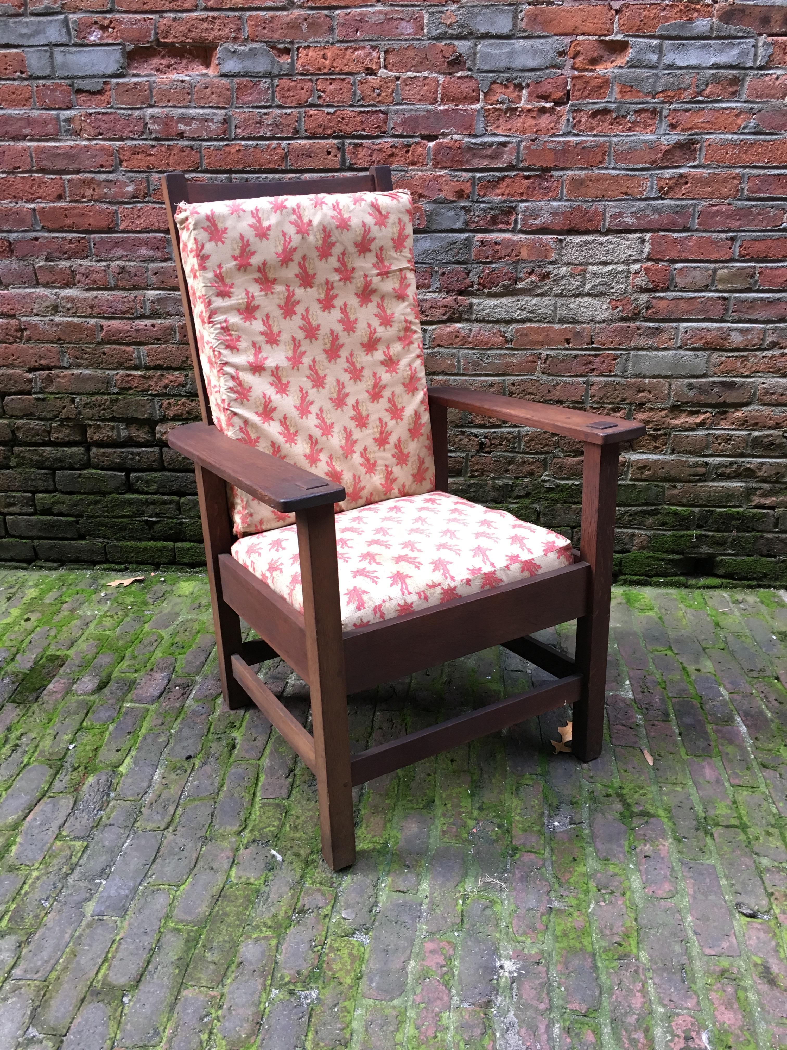Solid oak slat back Stickley Brothers armchair. Fully signed with metal Quaint Furniture, Stickley Brothers, Grand Rapids, Michigan tag, circa 1920. Good condition with overall wear and some chips to the rear legs (see photos). Original seat slats