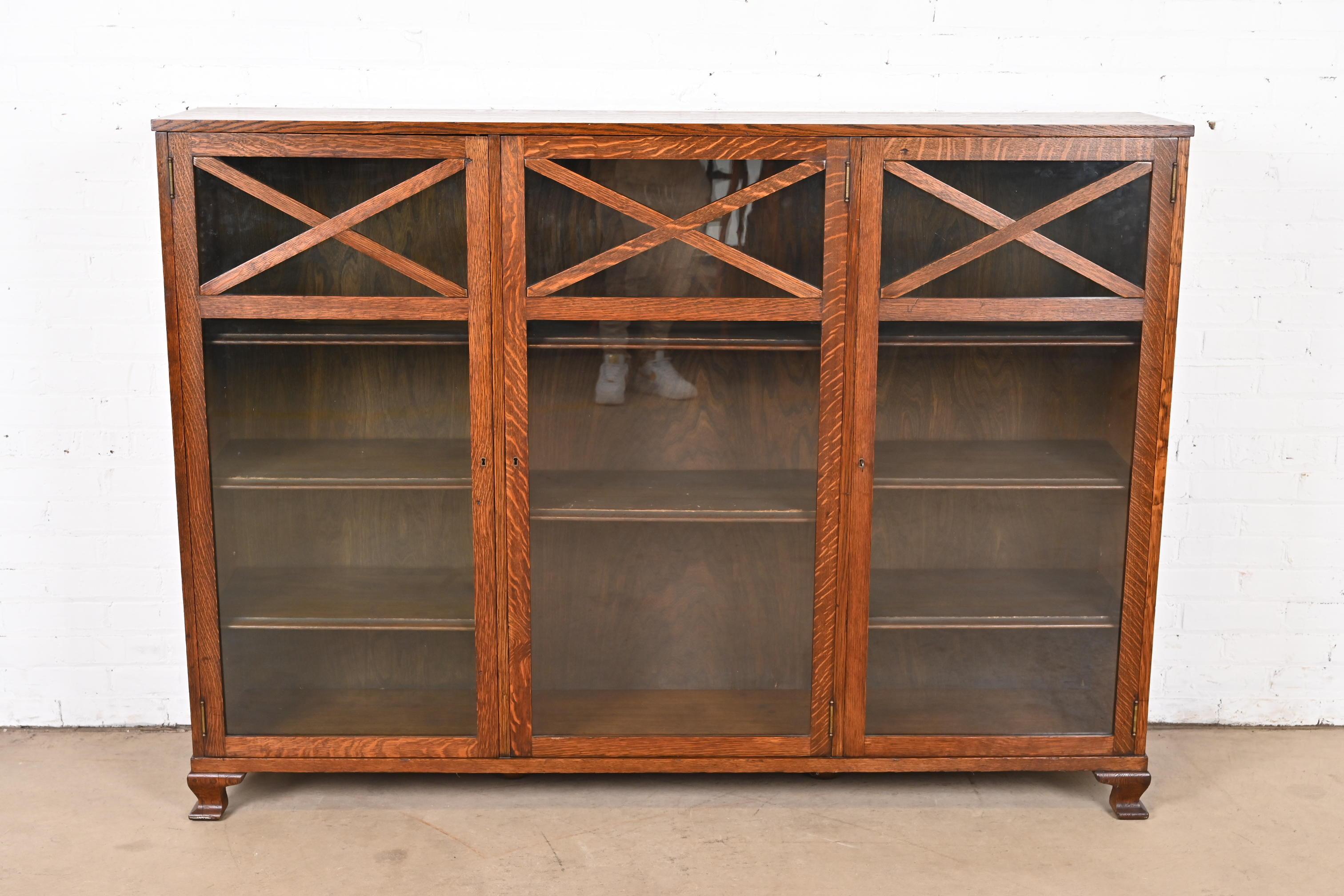 A beautiful antique Arts & Crafts triple bookcase cabinet

In the manner of Stickley Brothers

USA, Circa 1900

Gorgeous quarter sawn oak, with glass front doors. Cabinet locks, and original key is included.

Measures: 67