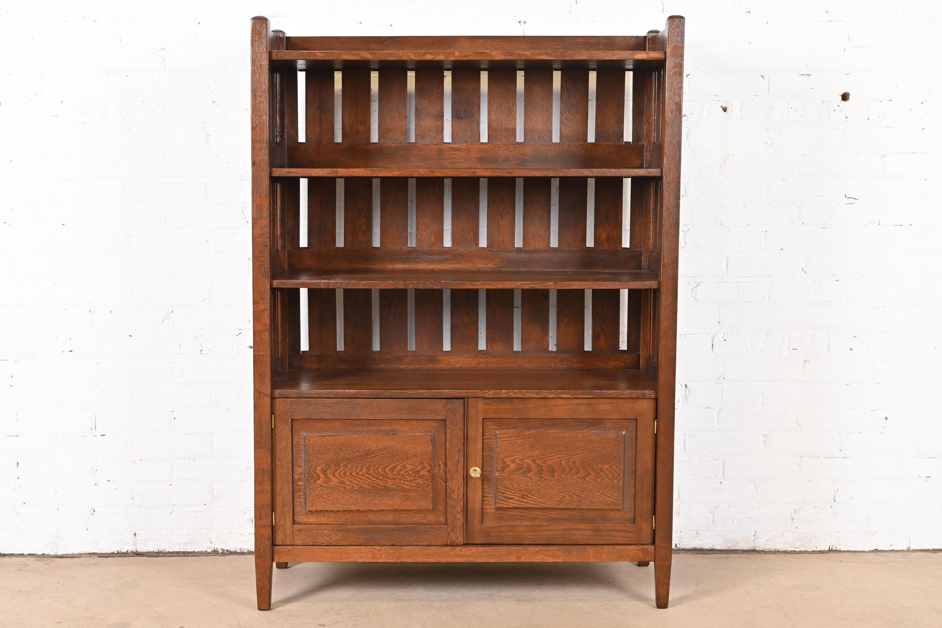 An exceptional antique Mission or Arts & Crafts bookcase

In the manner of Stickley Brothers

USA, Early 20th Century

Oak, with brass hardware. Lower cabinet locks, and key is included.

Measures: 39.25
