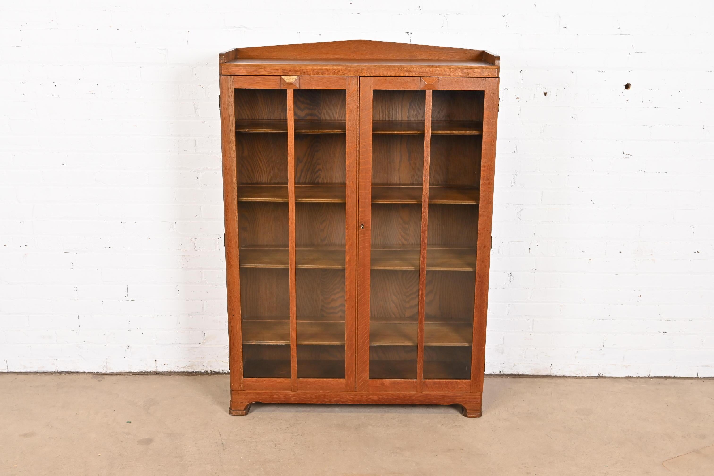 A beautiful Mission or Arts & Crafts period glass front bookcase or display cabinet

In the manner of Stickley Brothers

USA, Circa 1900

Gorgeous carved oak, with mullioned glass front doors. Cabinet locks, and key is included.

Measures: 38.5