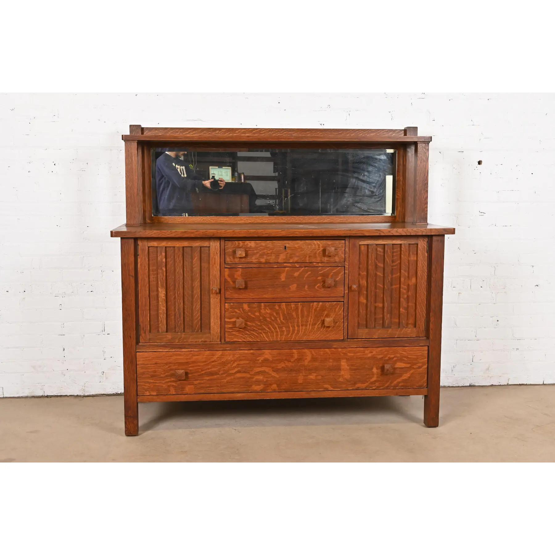 A gorgeous antique Mission or Arts & Crafts period sideboard, buffet server, or bar cabinet

In the manner of Stickley Brothers

By Grand Rapids Bookcase and Chair Co.

USA, Circa 1900

Gorgeous quarter sawn oak, with mirrored backsplash.

Measures:
