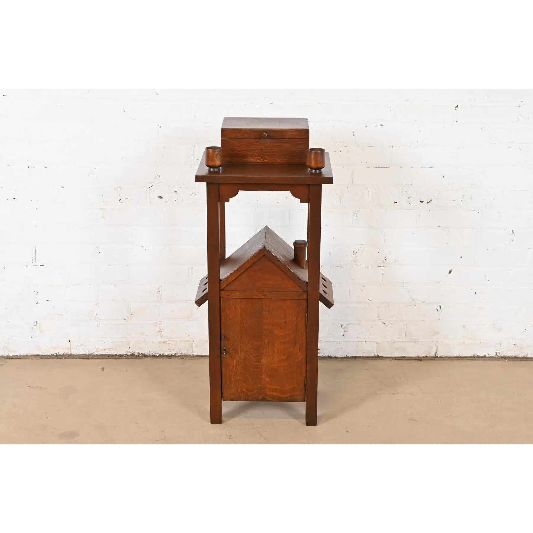 A very unique and exceptional antique Mission or Arts & Crafts period smoker's stand

In the manner of Stickley Brothers

By Grand Rapids Chair Co.

USA, Circa 1910

Quarter sawn oak, with metal-lined humidor and unique house-form cabinet. Cabinet