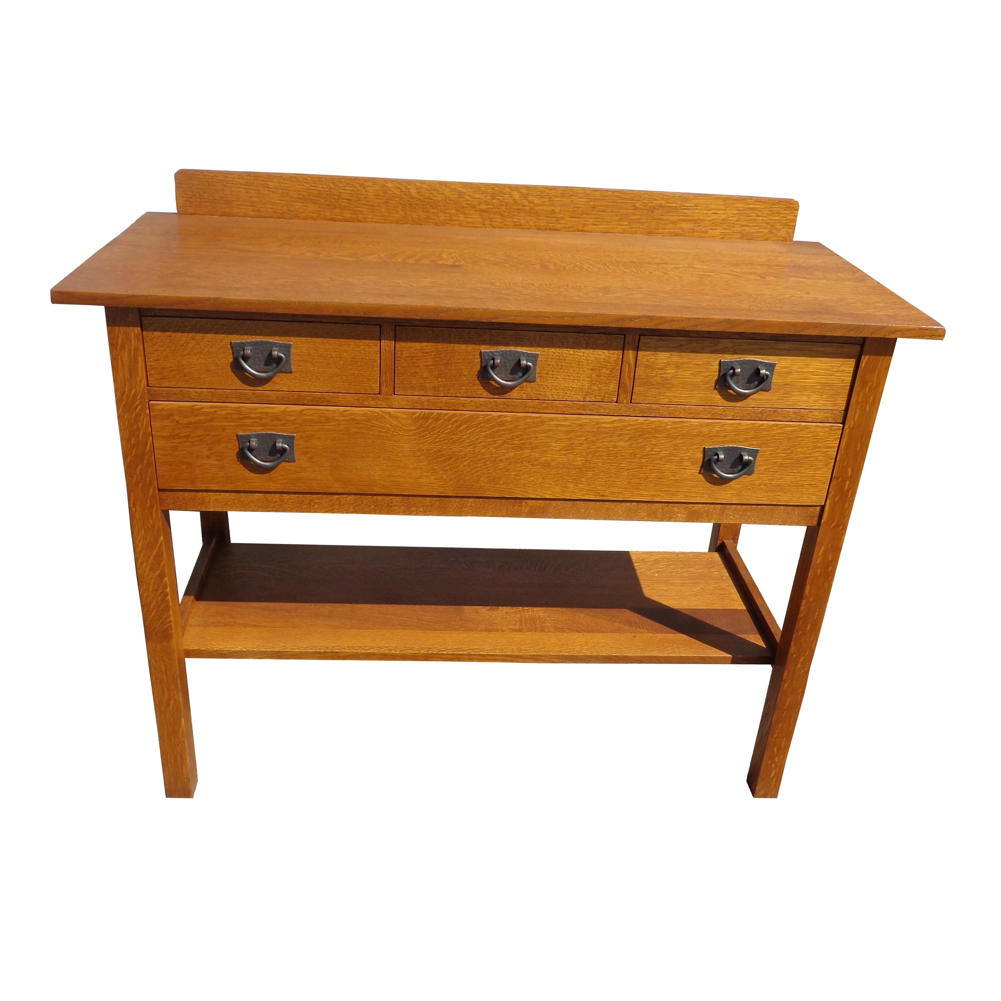 Stickley buffet side board W1209

Part of the reissued Mission collection late 20th century.

Gustav Stickley cherry four drawer sideboard or dresser. Overhanging top, wide lower shelf, and slightly tapered legs. The piece is signed with a branding