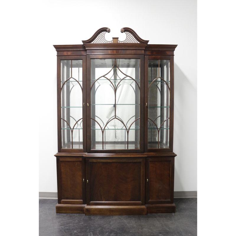 A Chippendale style breakfront china display cabinet by Stickley Furniture. Mahogany with brass hardware. Upper cabinet with three glass pane doors with Chippendale fretwork, glass side panels, nine adjustable glass shelves with plate grooves (6