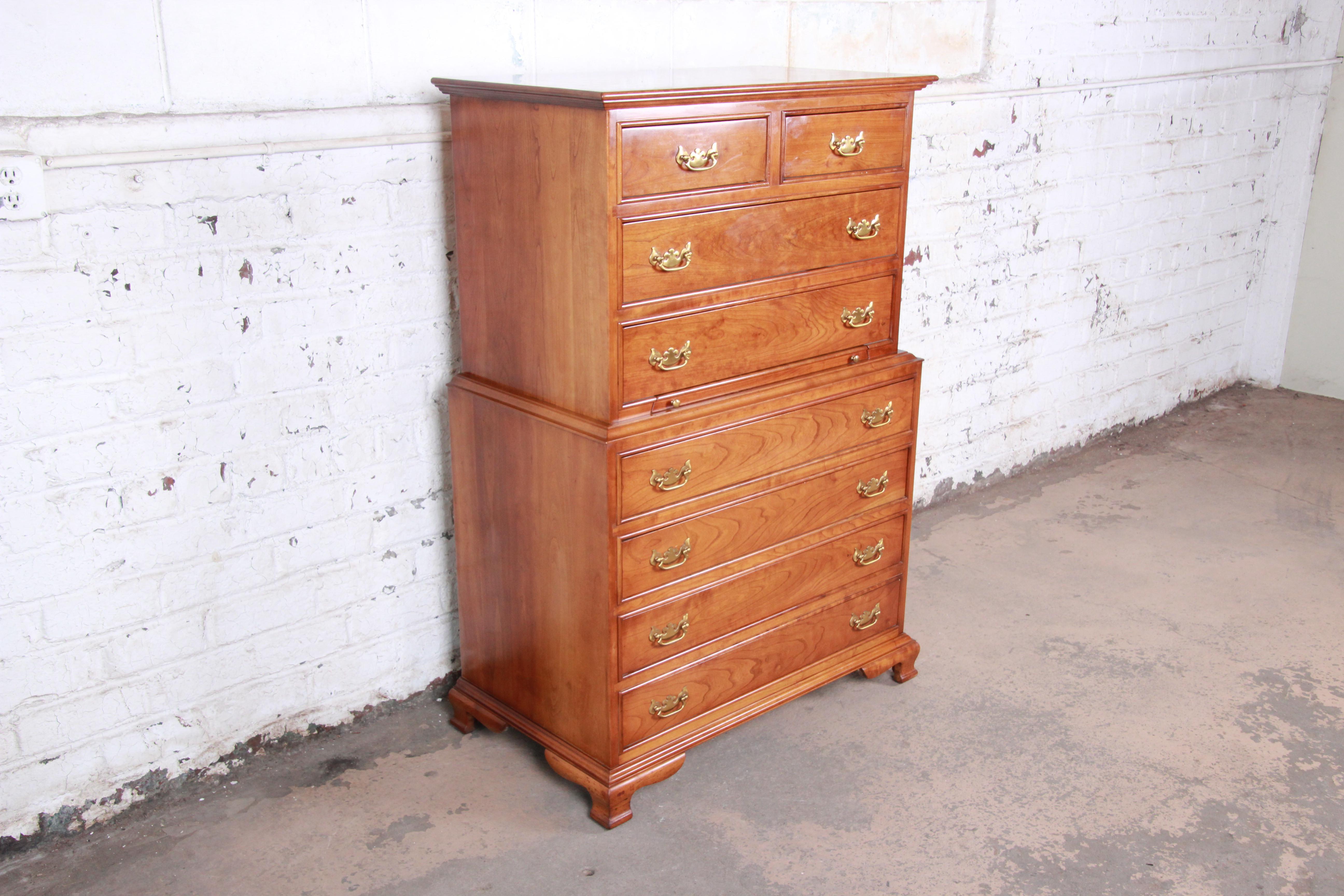 An exceptional Chippendale style highboy chest on chest dresser by L. & J.G. Stickley. The chest features gorgeous wood grain and solid cherrywood construction. It offers ample storage, with eight dovetailed drawers and a pull-out tablet. Brass