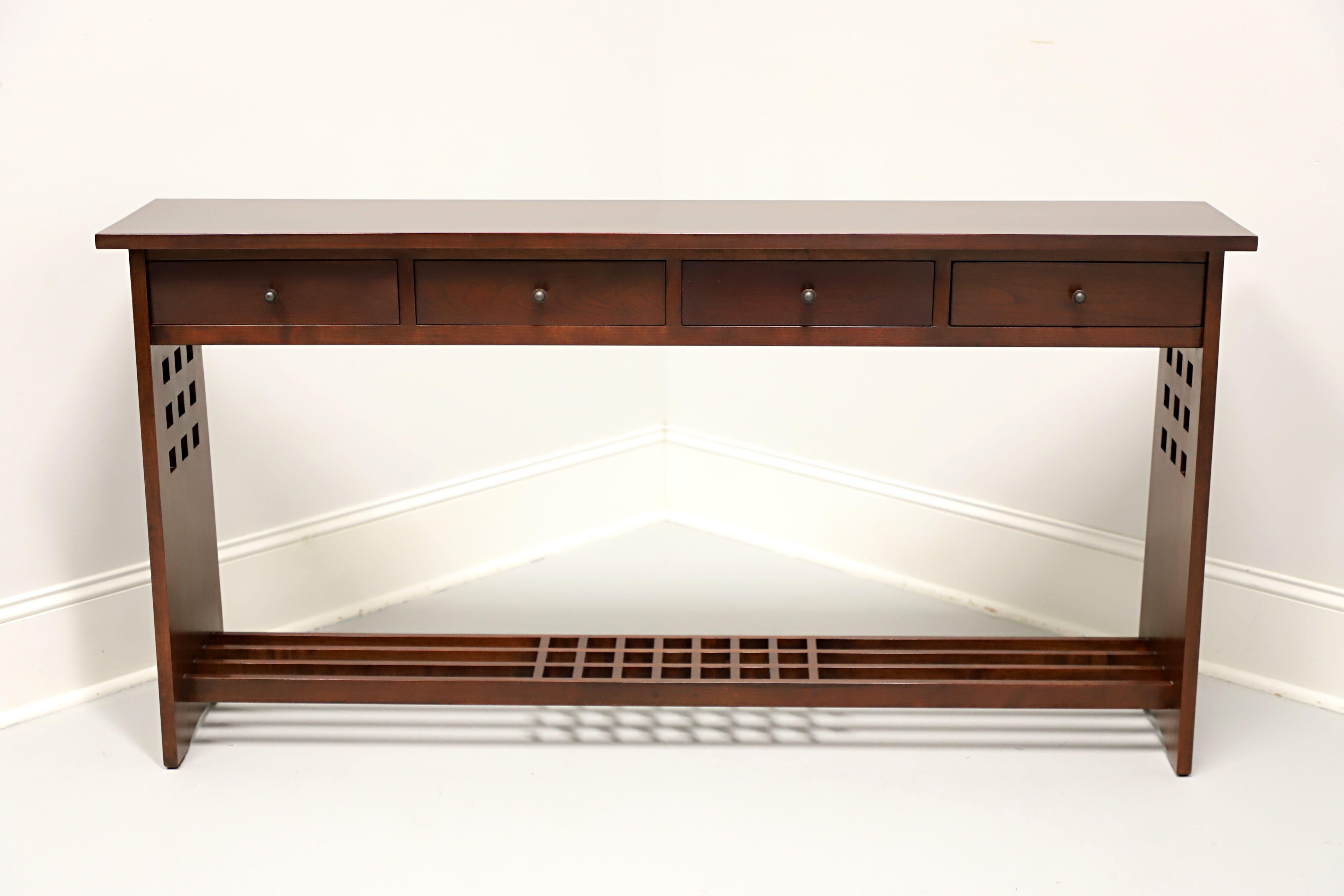 A Glasgow Arts & Crafts style console table by Stickley Furniture, from their Edinburgh Collection. Cherry wood with their Saratoga finish, square edge to top, dark copper hardware, open slat undertier shelf with decorative open squares design to