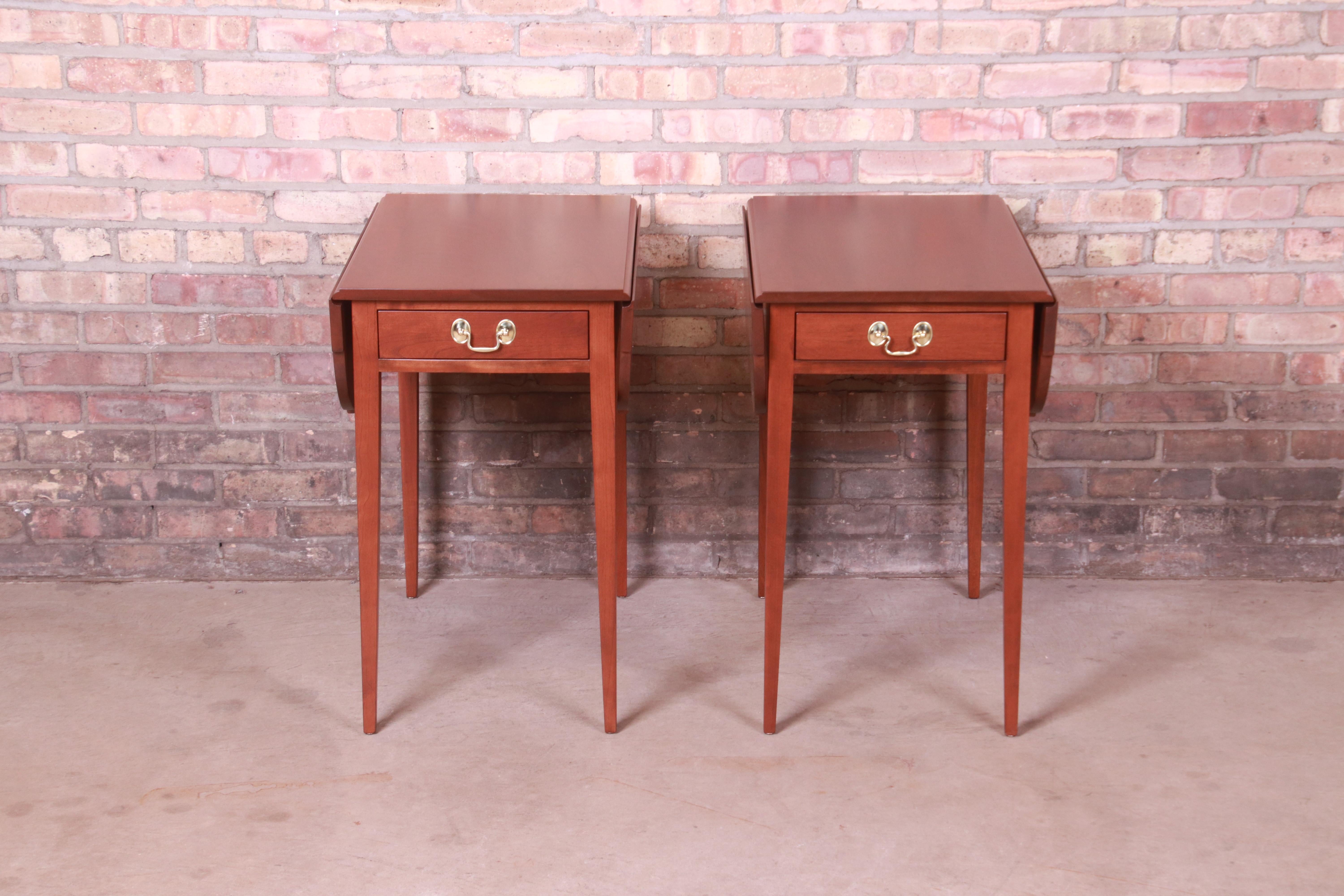 A gorgeous pair of Federal style Pembroke nightstands, end tables, or tea tables

By L. & J.G. Stickley

USA, late 20th century

Solid cherry wood, with original brass hardware.

Measures: 17