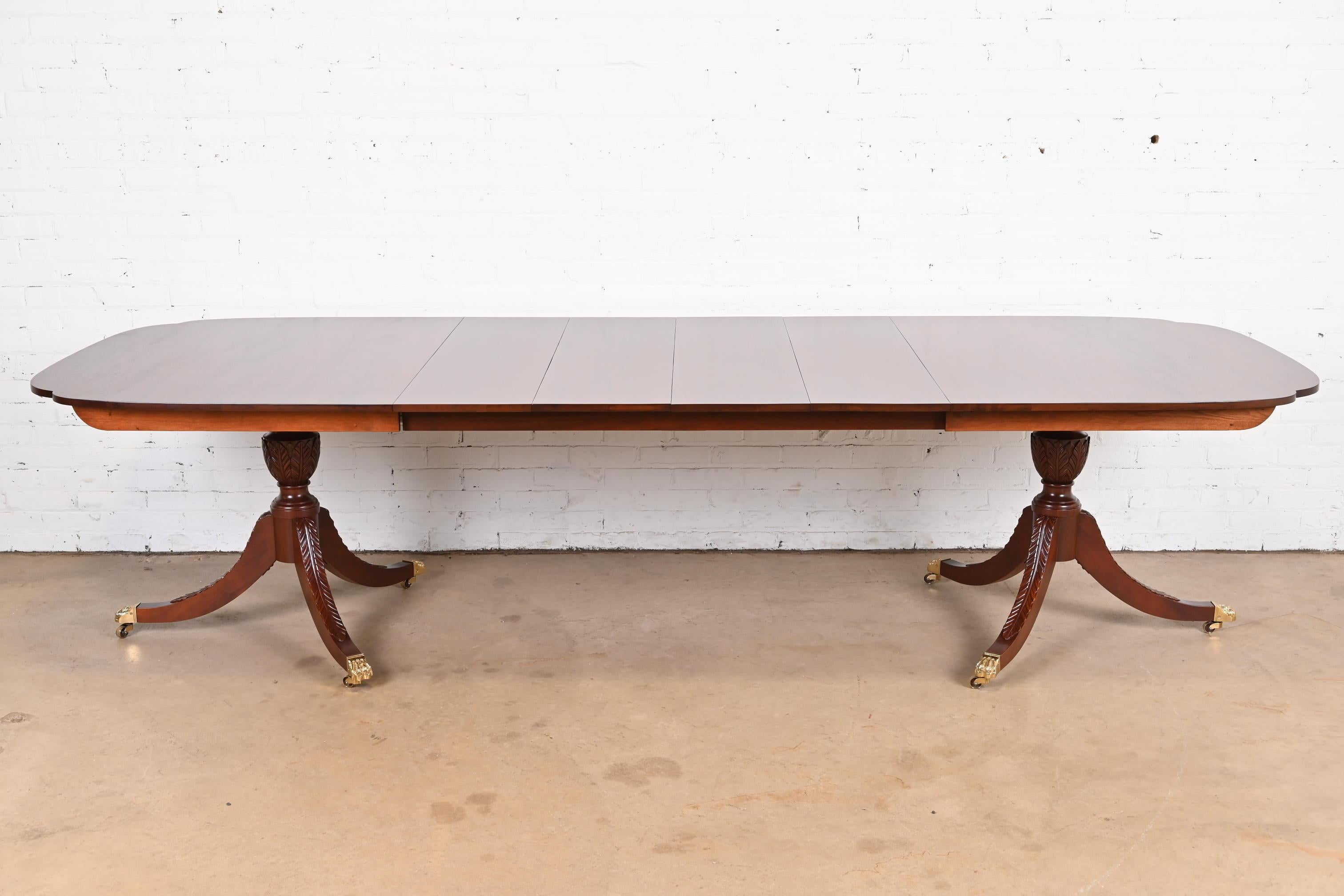 A gorgeous Georgian or Regency style double pedestal extension dining table

By Stickley

USA, Circa Late 20th Century

Carved solid mahogany, with brass-capped paw feet and castors.

Measures: 72.5