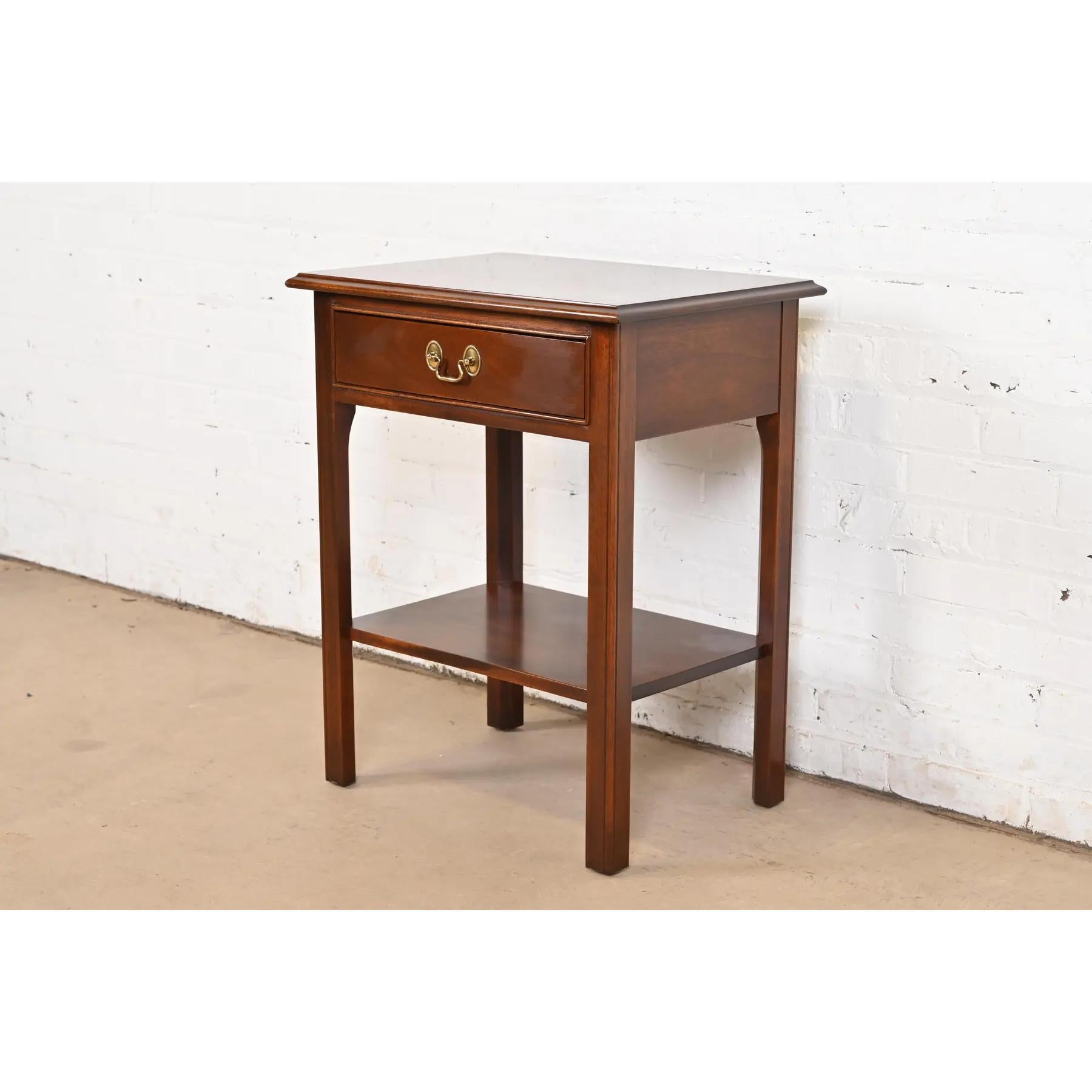 A gorgeous Georgian or Chippendale style nightstand or occasional side table

By Stickley

USA, Late 20th Century

Carved mahogany, with original brass hardware.

Measures: 21.88