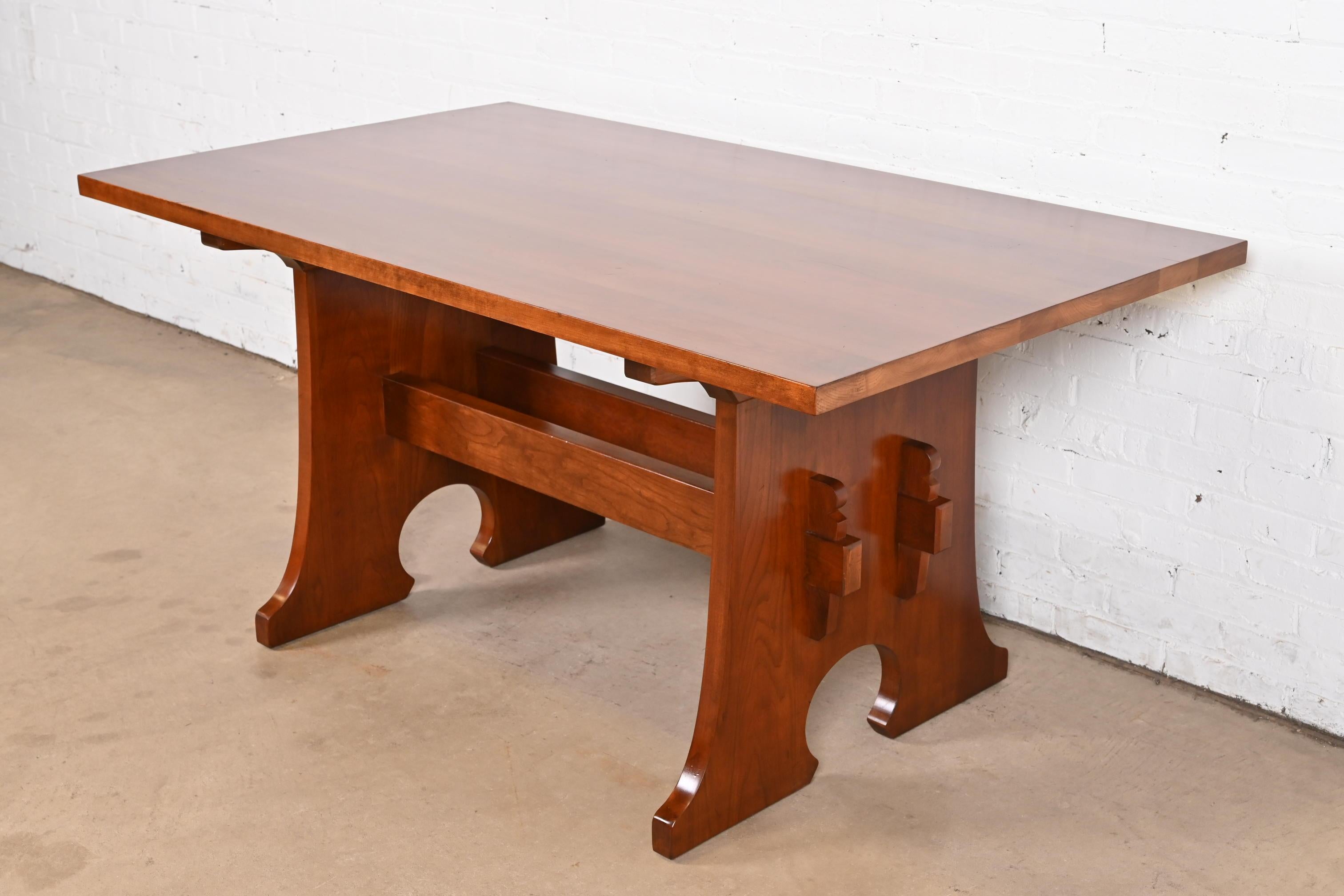An exceptional Mission or Arts & Crafts solid cherry wood trestle dining table, library table, or writing desk

By L. & J.G. Stickley

USA, 2008

Measures: 62