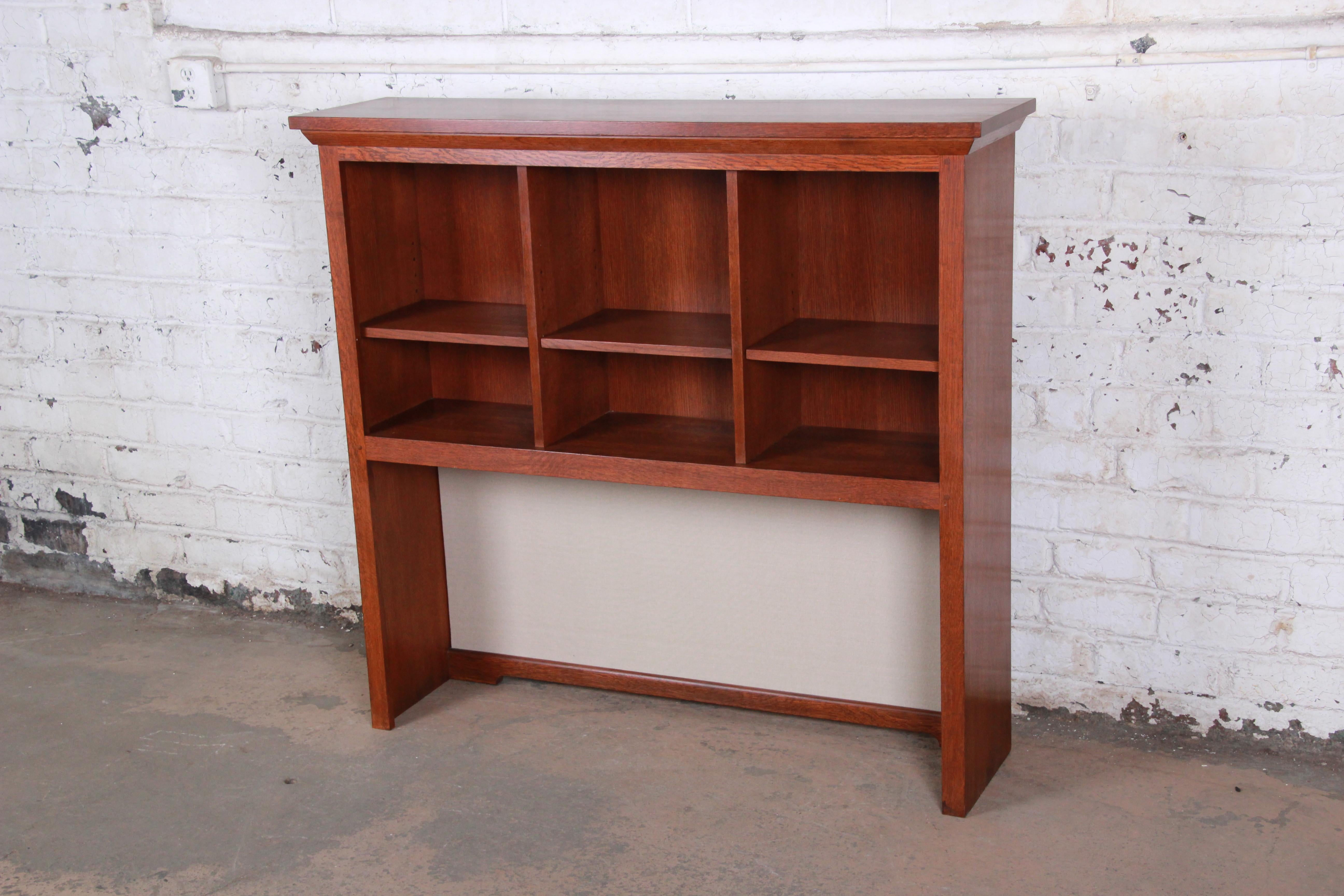 A beautiful solid oak Mission Arts & Crafts bookcase or hutch. It features three cubbies with an adjustable shelf in each and open storage below.

By Stickley,

circa 1990s

Measures: 51.25
