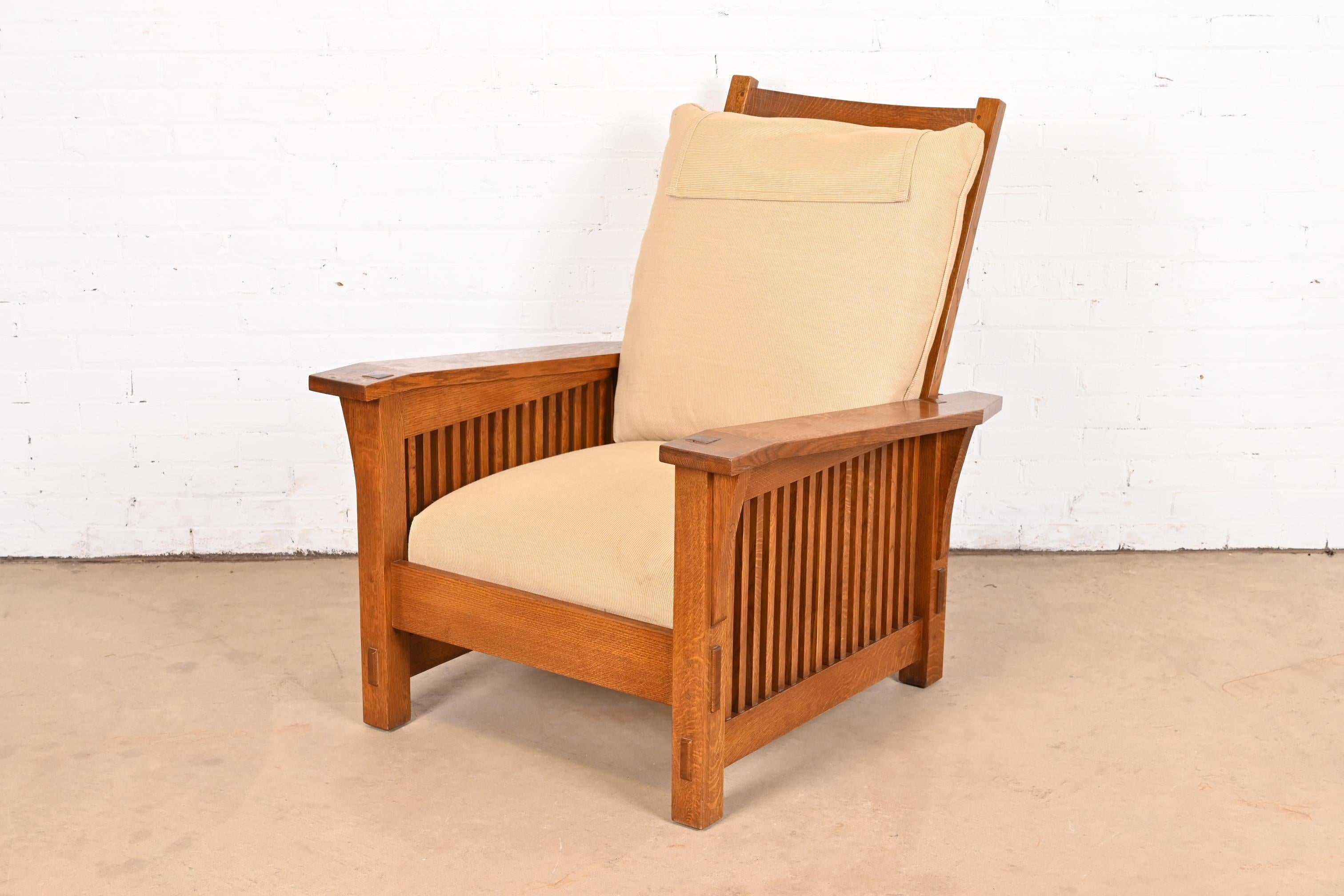 A gorgeous Mission or Arts & Crafts Morris reclining lounge chair

By L. & J.G. Stickley

USA, Circa Late 20th Century

Carved oak frame, with tan upholstered seat and back cushions.

Measures: 32.75