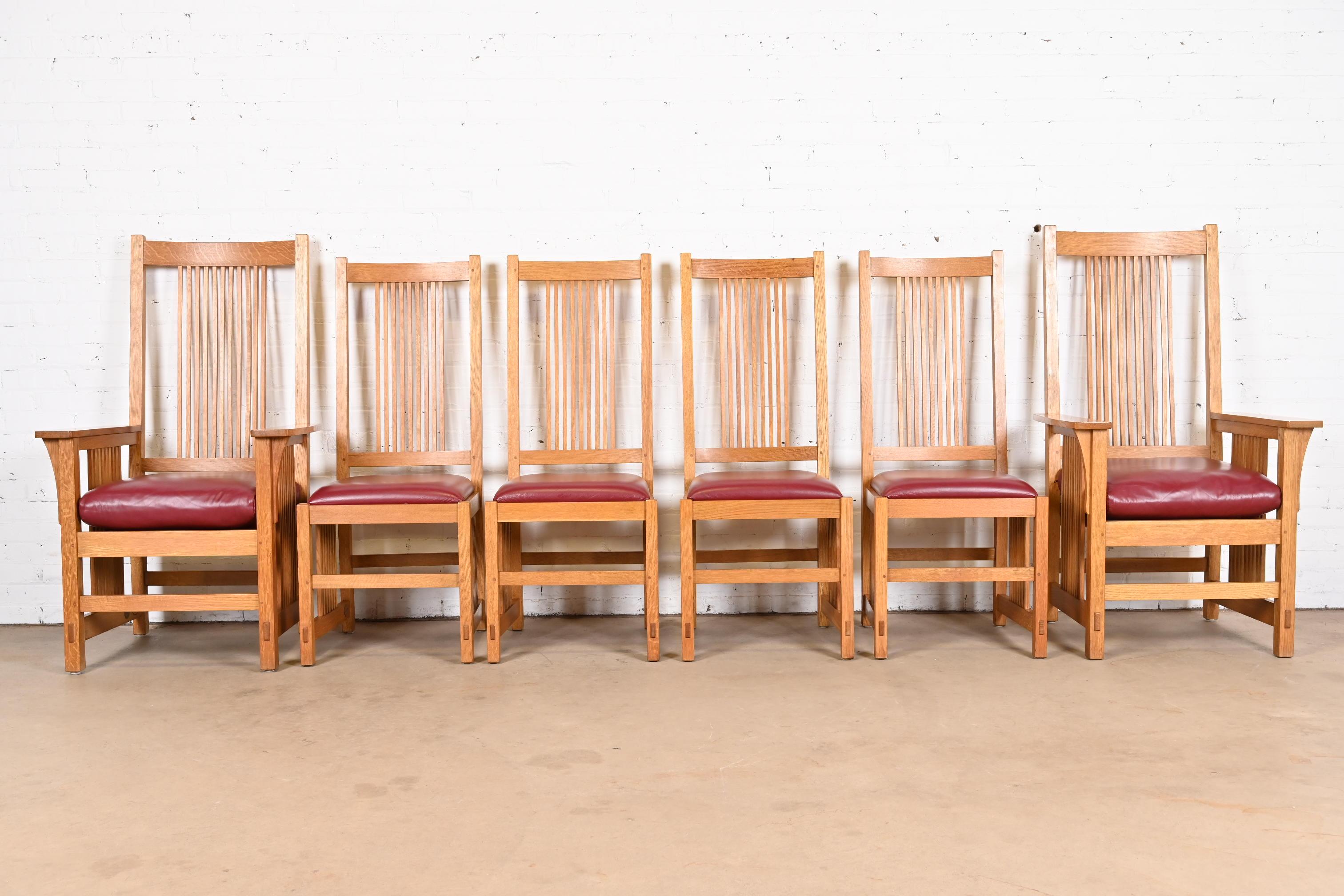 An exceptional set of six Mission or Arts & Crafts style dining chairs

By L. & J.G. Stickley

USA, Late 20th Century

Solid quarter sawn oak frames, with burgundy leather upholstered seats.

Measures:
Side chairs - 19