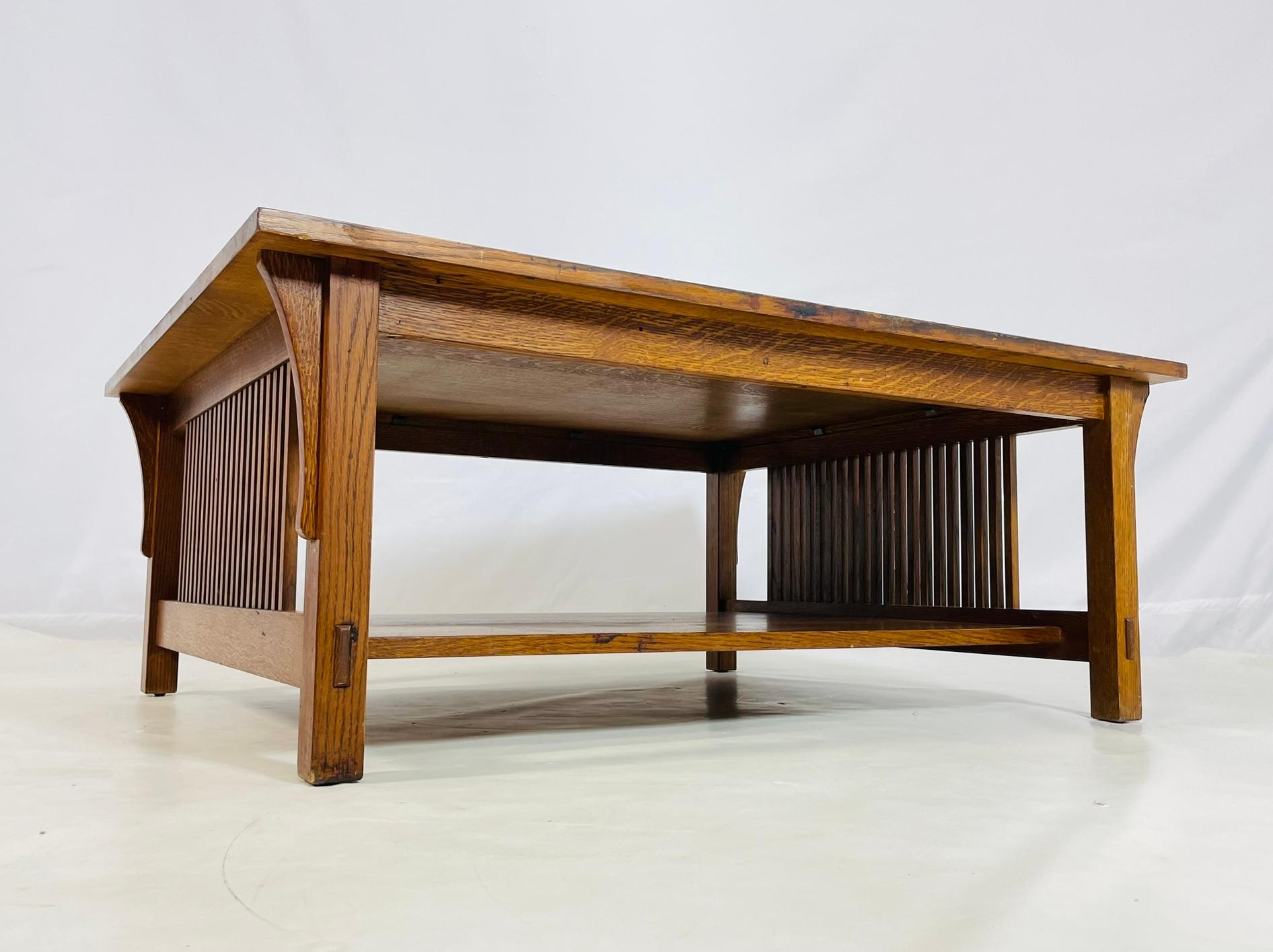 A beautifully crafted Mission-style coffee table by Stickley, dated 1995, constructed in quarter-sawn oak with slatted sides and a rich medium-toned finish. The table features exposed joinery, a spacious rectangular top, and a practical lower shelf