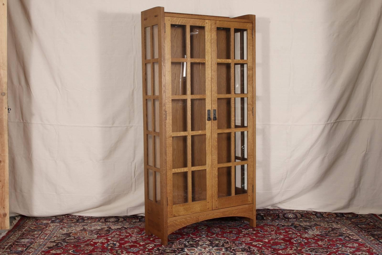 Stickley oak Art & Crafts tall display cabinet, four glass shelves, glass panels on sides as well. Interior lights.

Condition: Expected wear and signs of use including some light surface scratching and sporadic nicking along corners and edges.