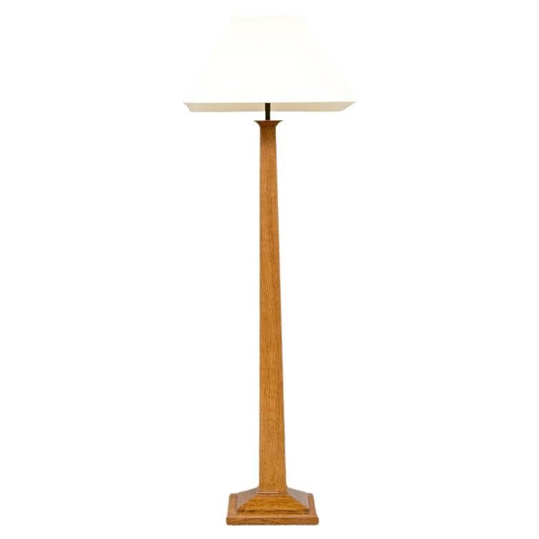 Stickley oak square floor lamp with conforming linen shade and a two pull chain operation. The lamp with a tapering standard and a tiered square base. Burned-in Stickley logo, Model #89-036, produced March 10, 1999.

Dimensions: 19.25