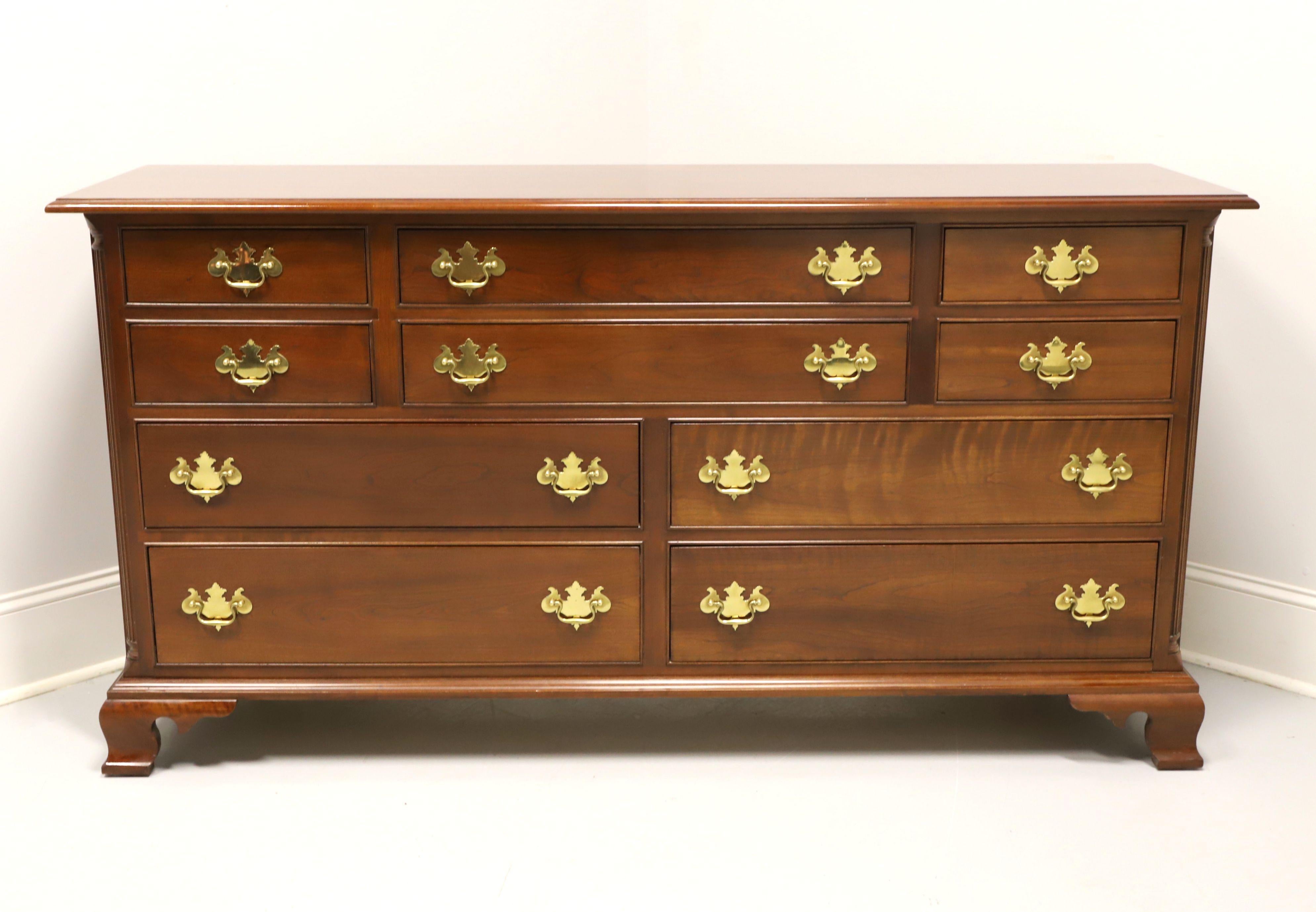 A Chippendale style triple dresser by Stickley Furniture, a Leopold Stickley original. Solid cherry with brass hardware, smooth top with ogee edge, decorative fluted columns at front sides and ogee bracket feet. Features ten various size drawers of