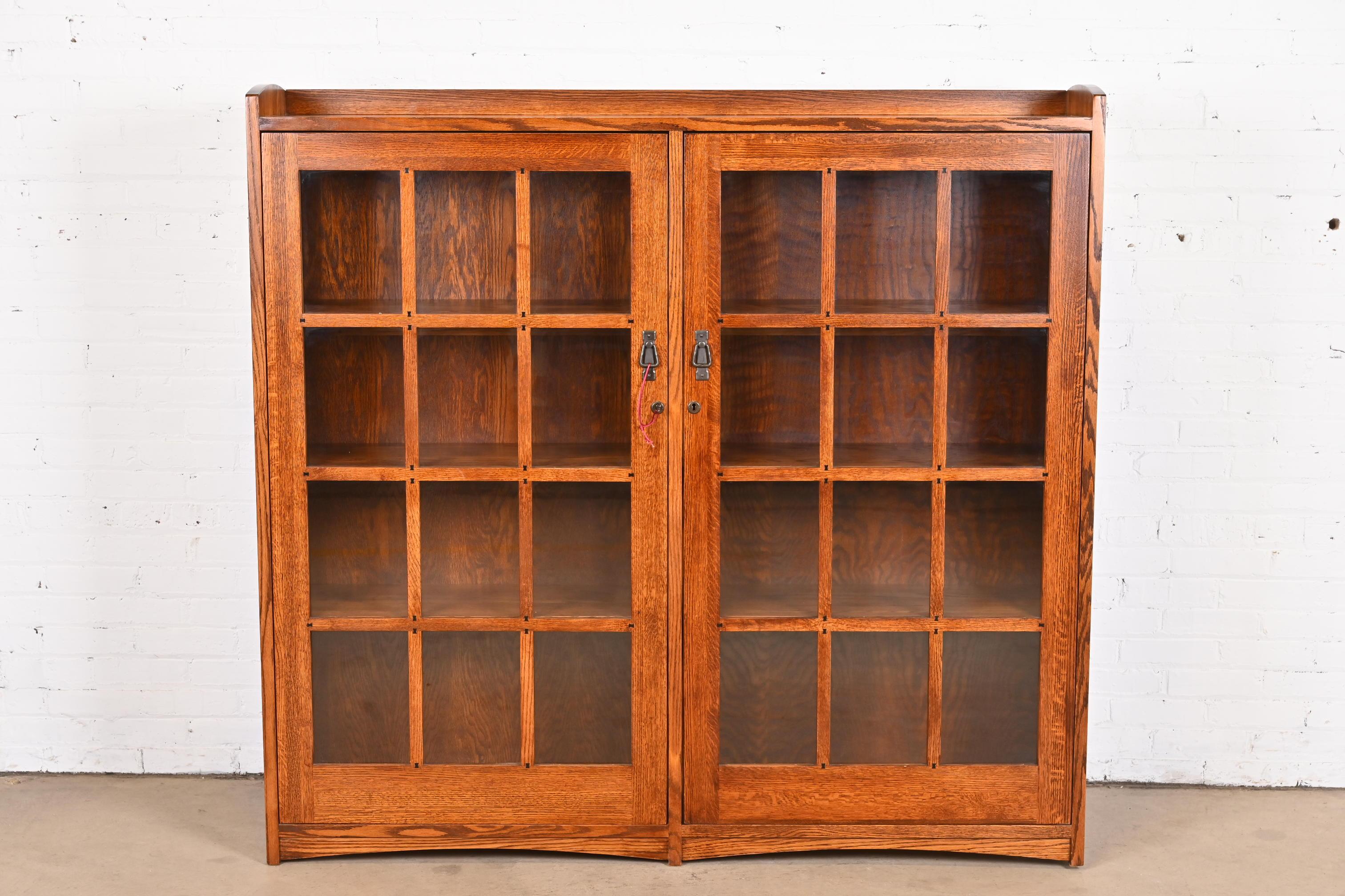 A beautiful Mission oak Arts & Crafts bookcase cabinet

In the manner of Stickley

USA, Late 20th Century

Solid oak, with mullioned glass front doors, and original hardware. Cabinets lock, and key is included.

Measures: 63.25