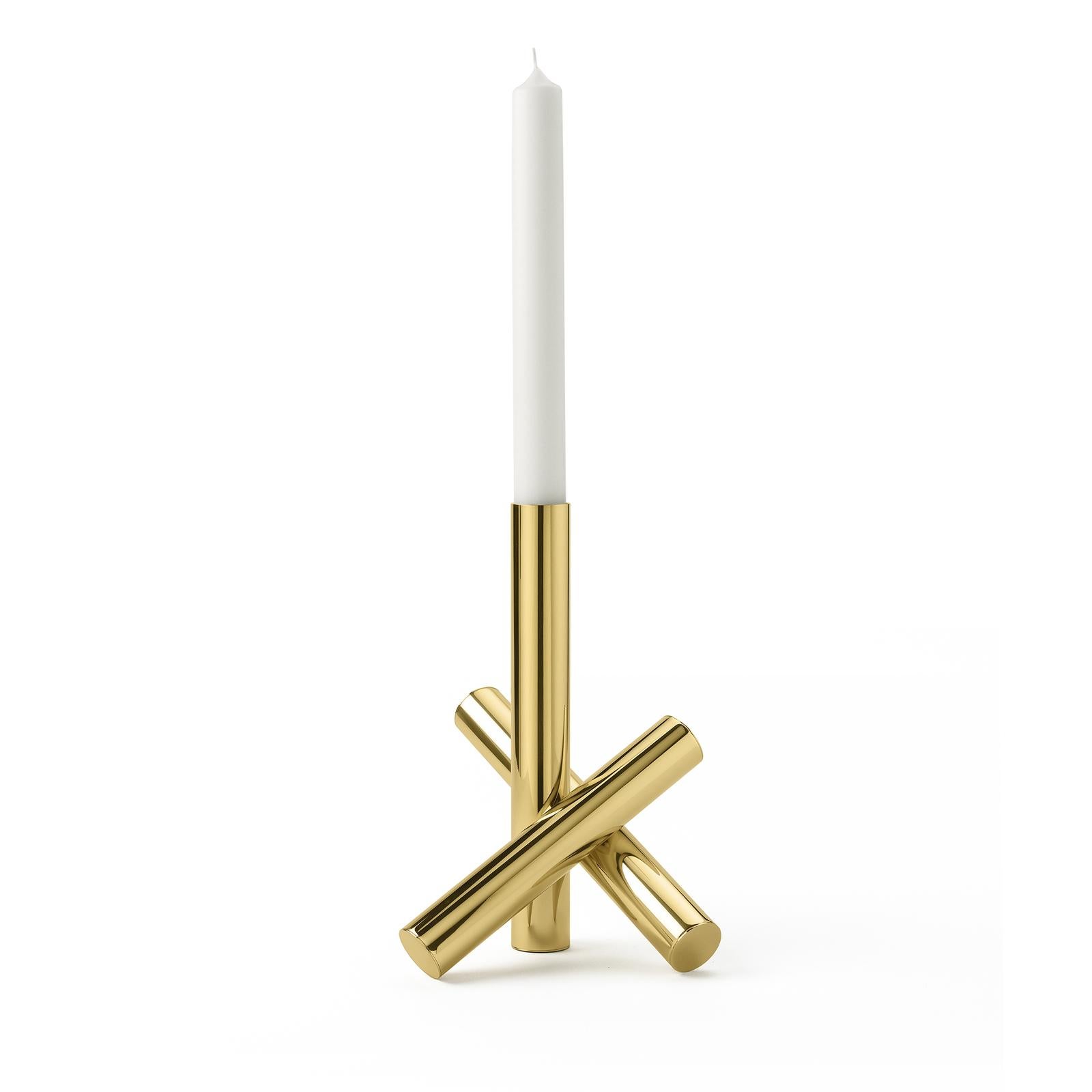 An abstract interpretation of crossed twigs, this candle holder poetically evokes the powerful dynamism of fire, with its three brass elements. Two diagonal pieces cross to support the vertical candle holder in this exquisite sculptural object