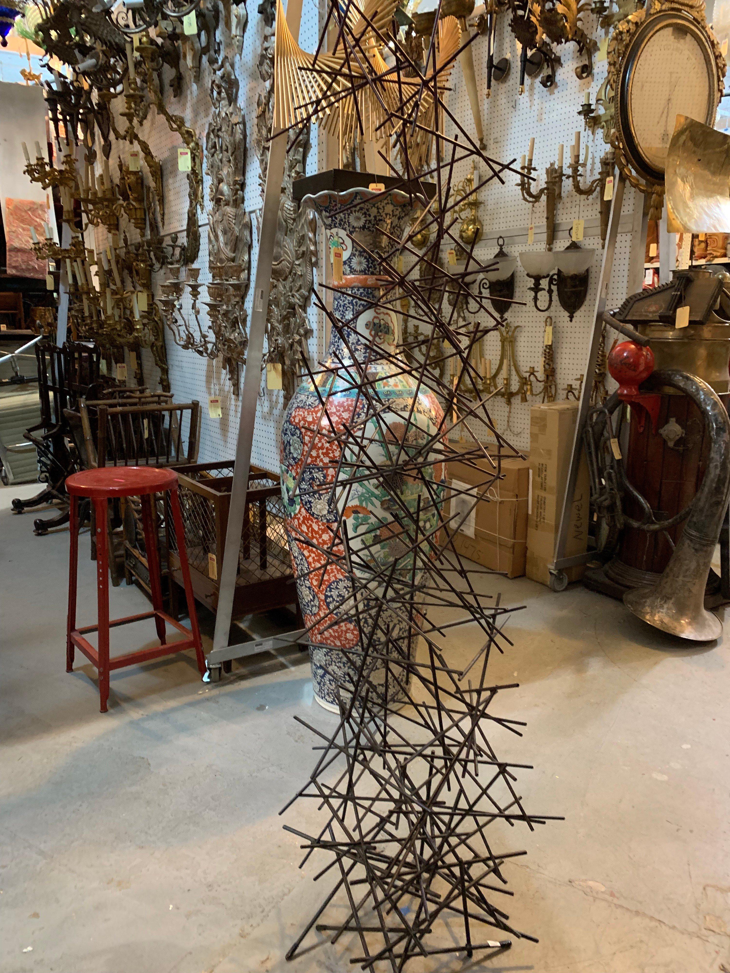 Contemporary large metal floor sculpture featuring rods abstractly welded into a tower (titled: 