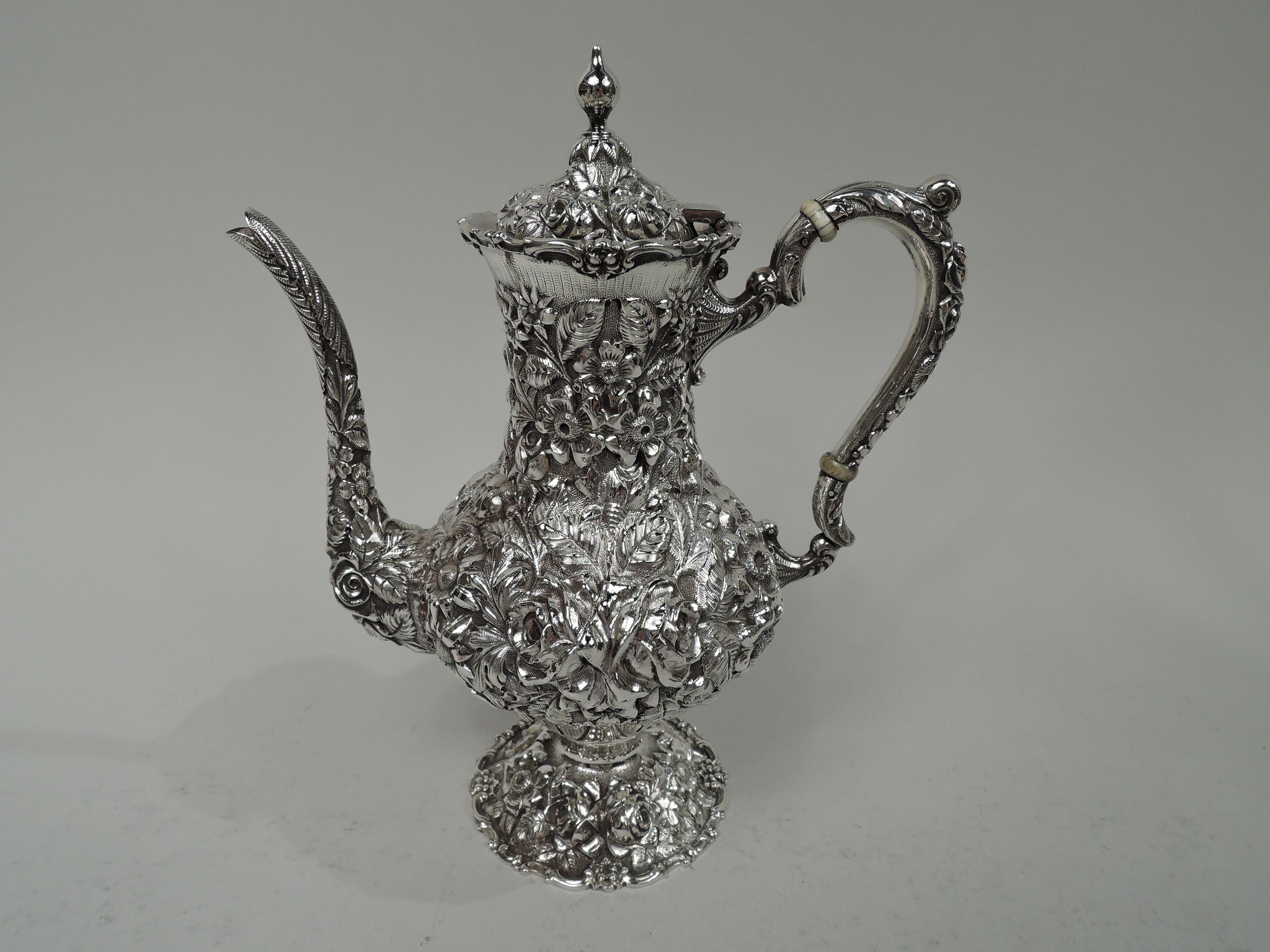 Edwardian sterling silver 3-piece coffee set. Made by Stieff in Baltimore in 1918. This set comprises coffeepot, creamer, and sugar. Each: Bellied bowl on raised foot. Handles high-looping and leaf-capped. Covers domed with vasiform finial.