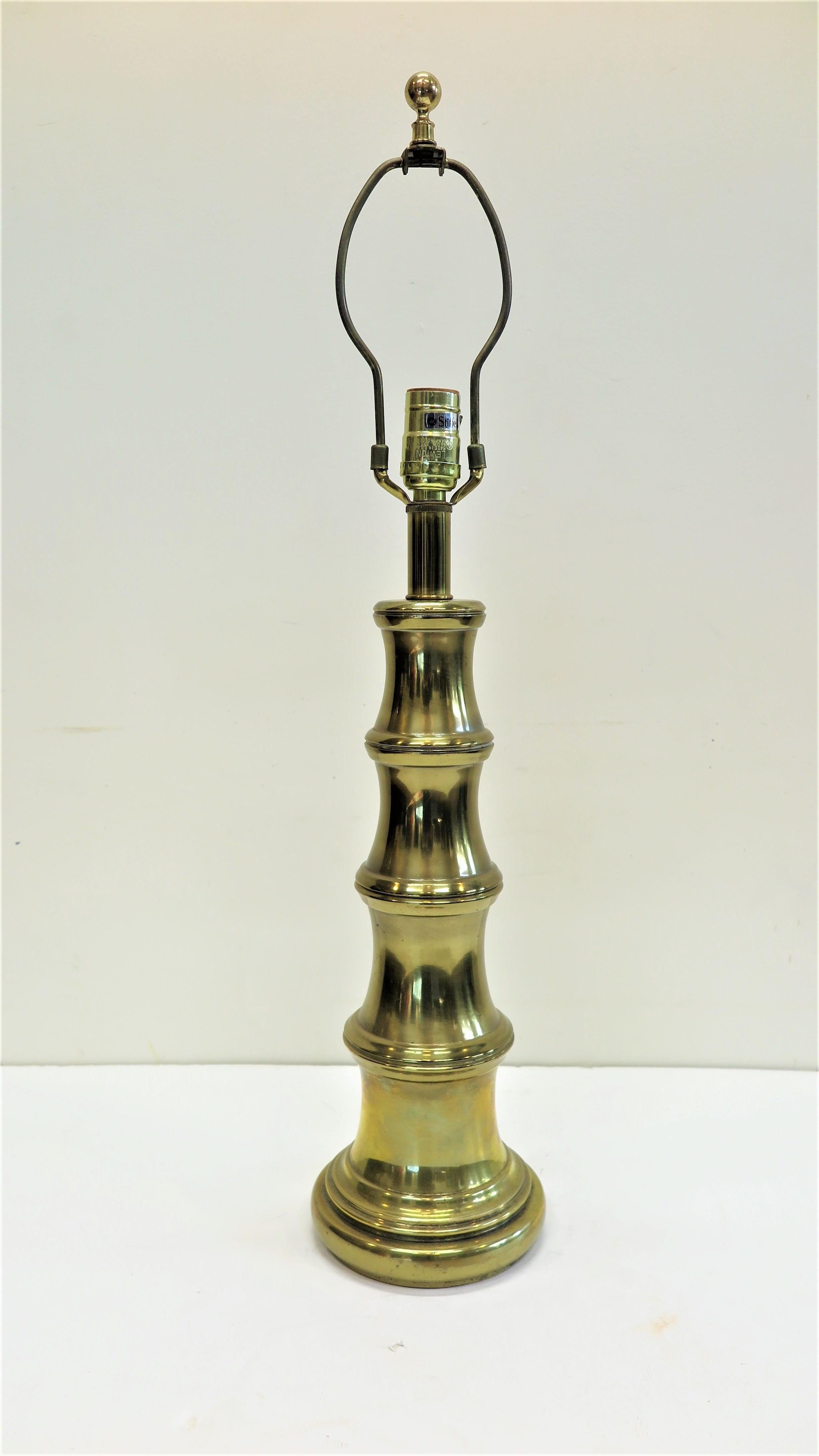 Stiffel brass bamboo style table lamp. Stiffel brass table lamp having a shape simulating Bamboo. Very good condition. Having a three way switch. Quality made solid brass table lamp American 1950-60. 
Picture of lamp with shade is only for
