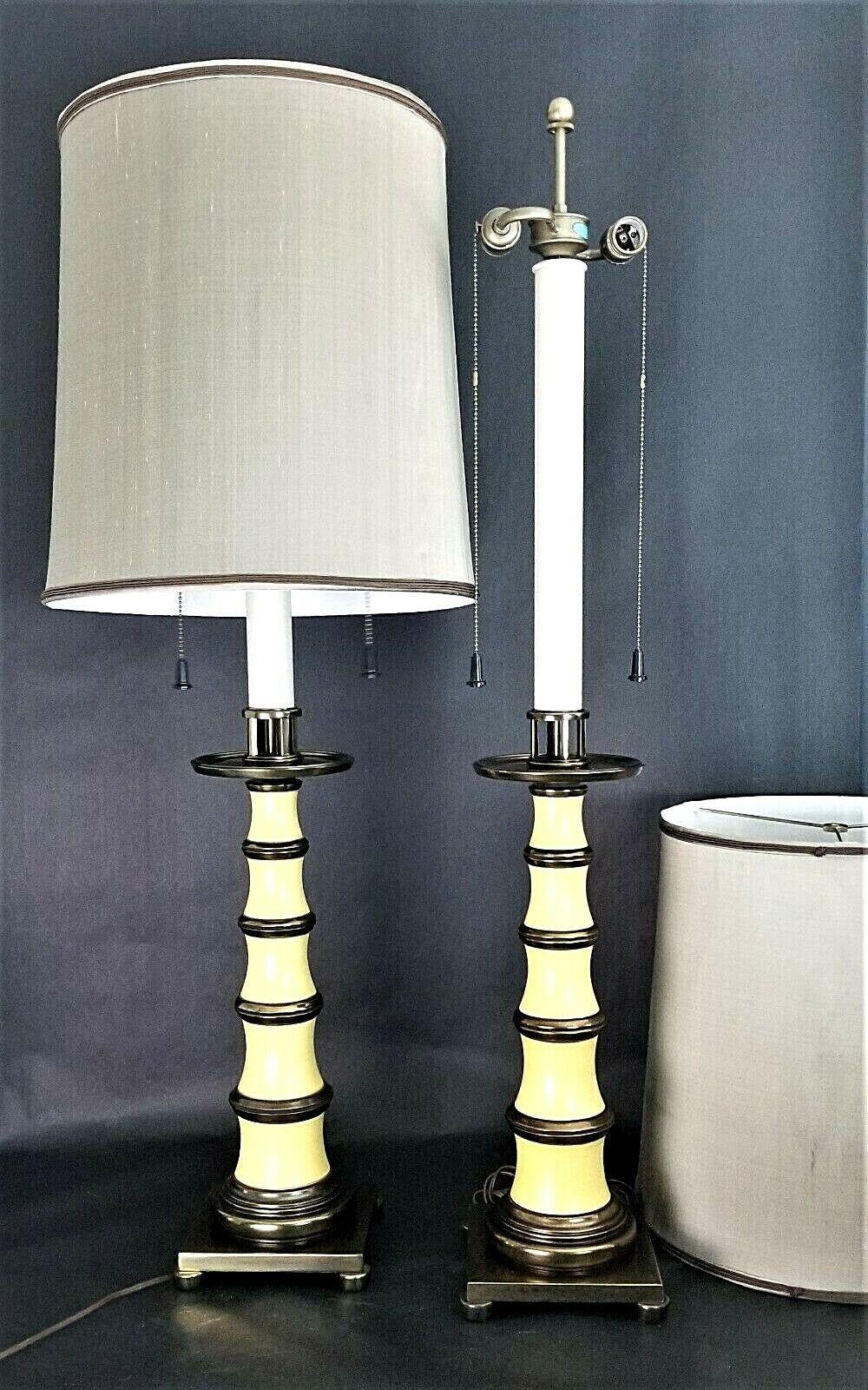 For FULL item description click on CONTINUE READING at the bottom of this page.

Offering One Of Our Recent Palm Beach Estate Fine Lighting Acquisitions Of A
Pair of Vintage Stiffel Enamel and Brass Candlestick Dual Socket Table Lamps with Dupioni