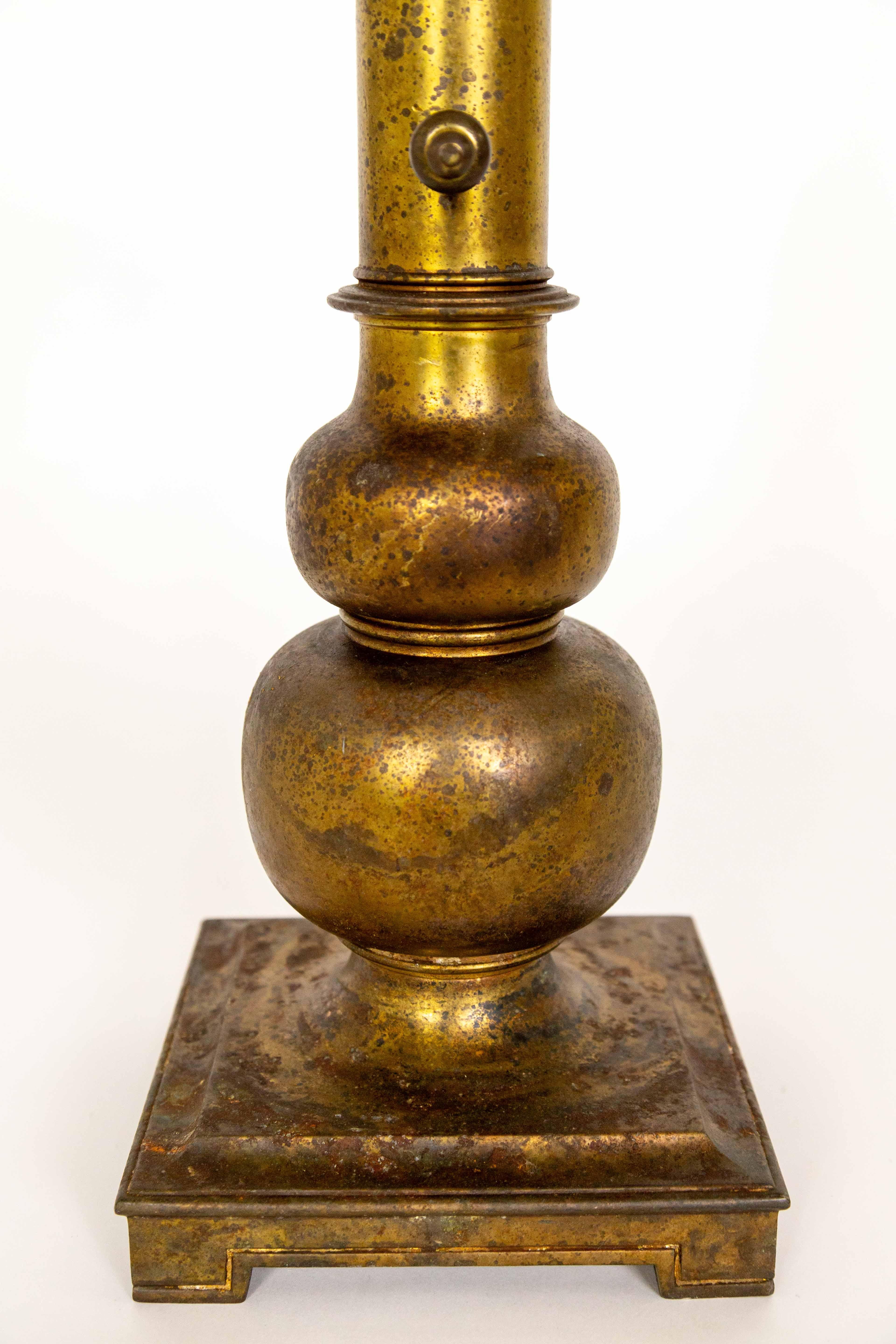 A tall, brass table lamp with an aged patina. A column shape with a bulbous bottom and square base. Made by Stiffel in the mid-20th century. Newly rewired a dimmer on the socket. 7