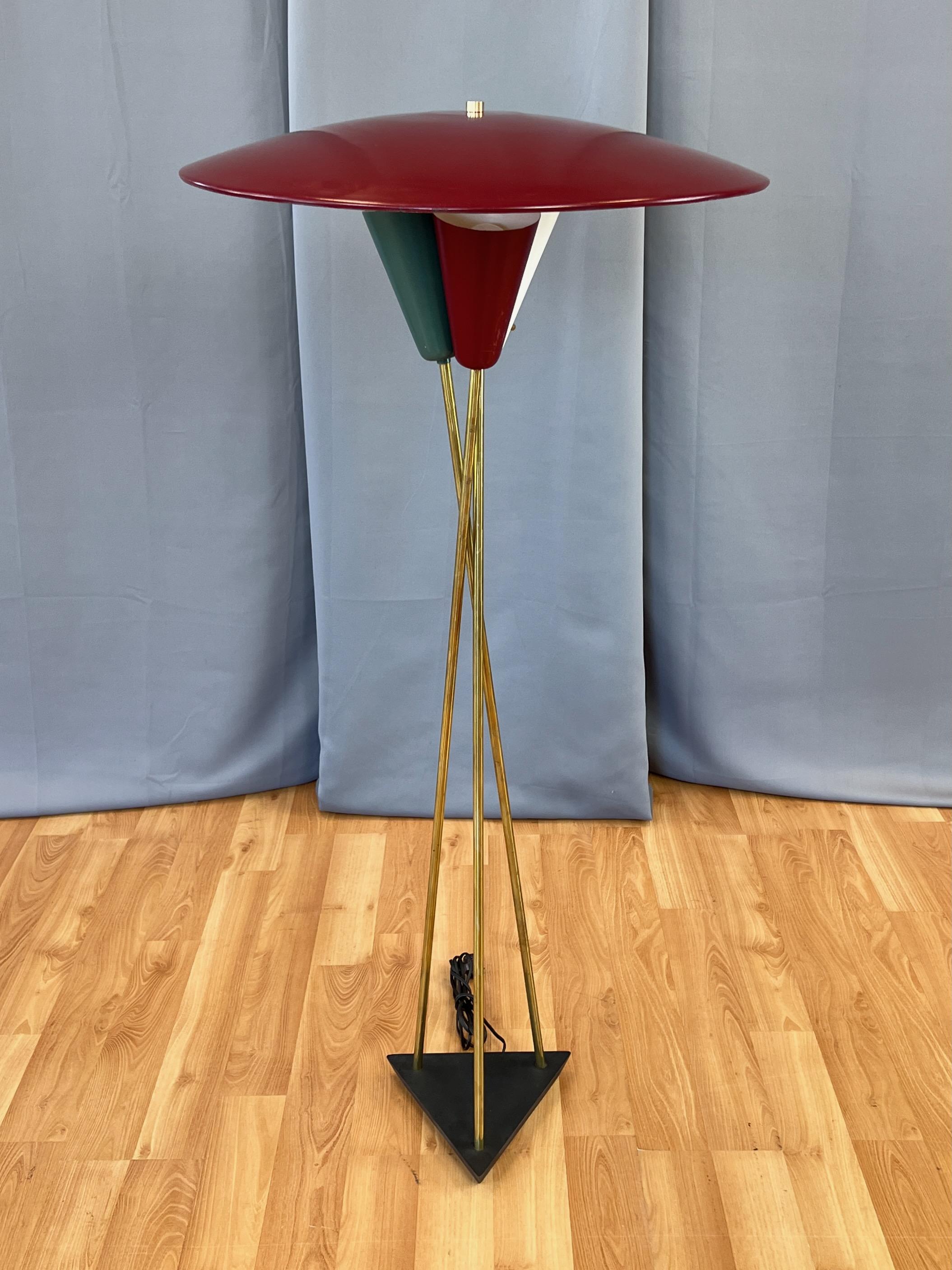 A very striking and uncommon 1950s Stiffel mid-century modern atomic-style floor lamp with large saucer shade and three shaded uplights on brass rods and black metal base.

Twenty-four-inch-diameter saucer shade on positionable ball joint finished