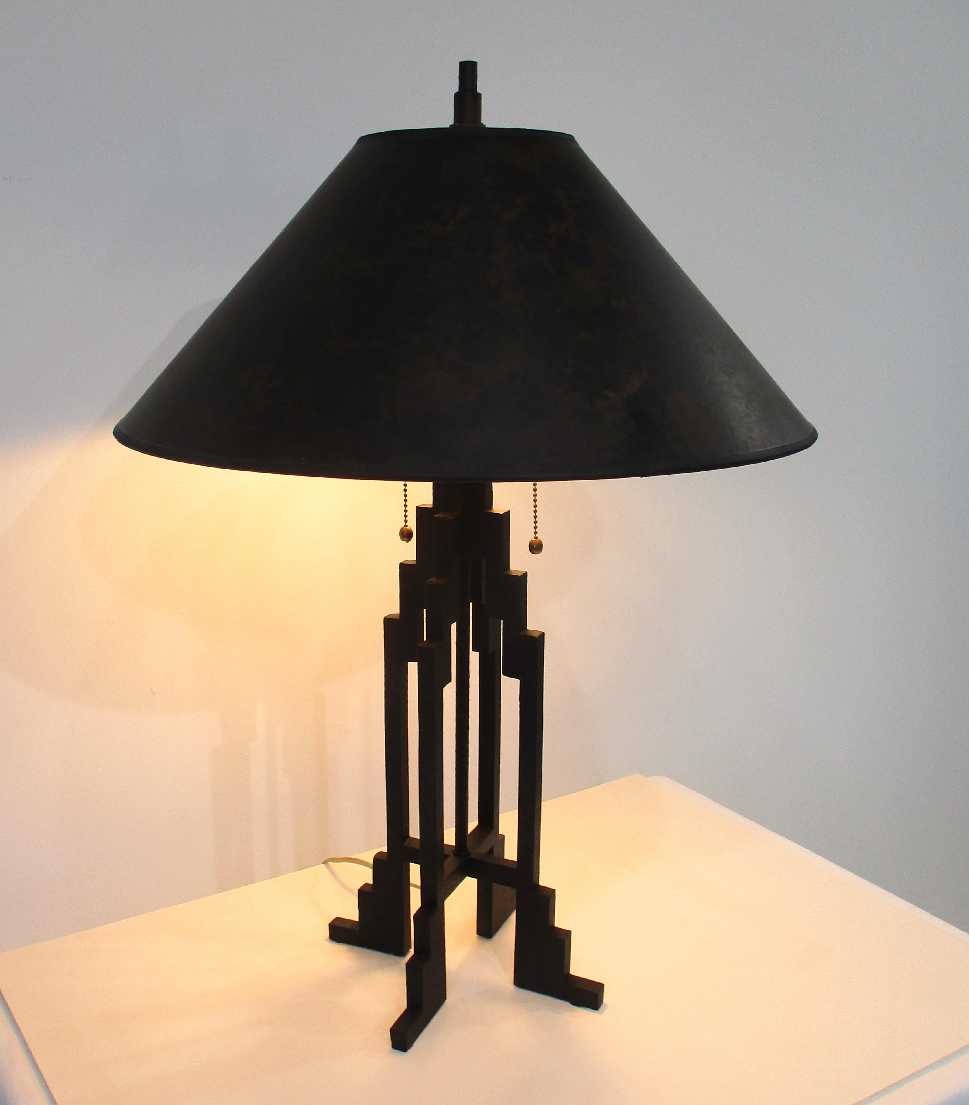 A unique satin black iron step up Skyscraper table lamp with the original molten patterned shade . Manufactured by Stiffel with drop down brass pull chain switches having balls to the ends . This lamp could work with an Art Deco , industrial or