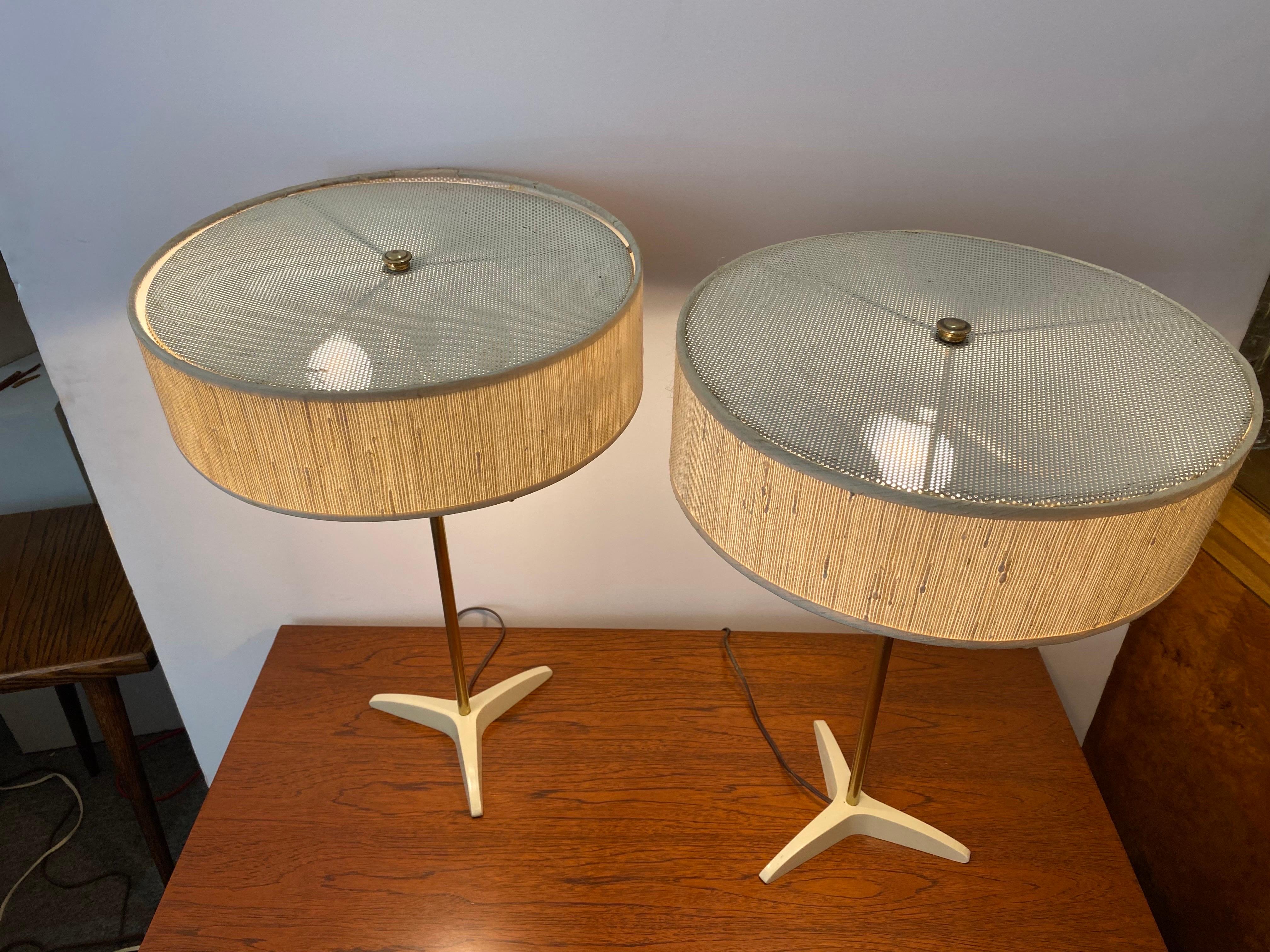 Pair of Stiffel brass pole table lamps. Newly recovered shades with the original frames. Two pull chain cords allow for one or two bulbs to be turned on. Elegant Simple Design! Retains Stiffel labels.