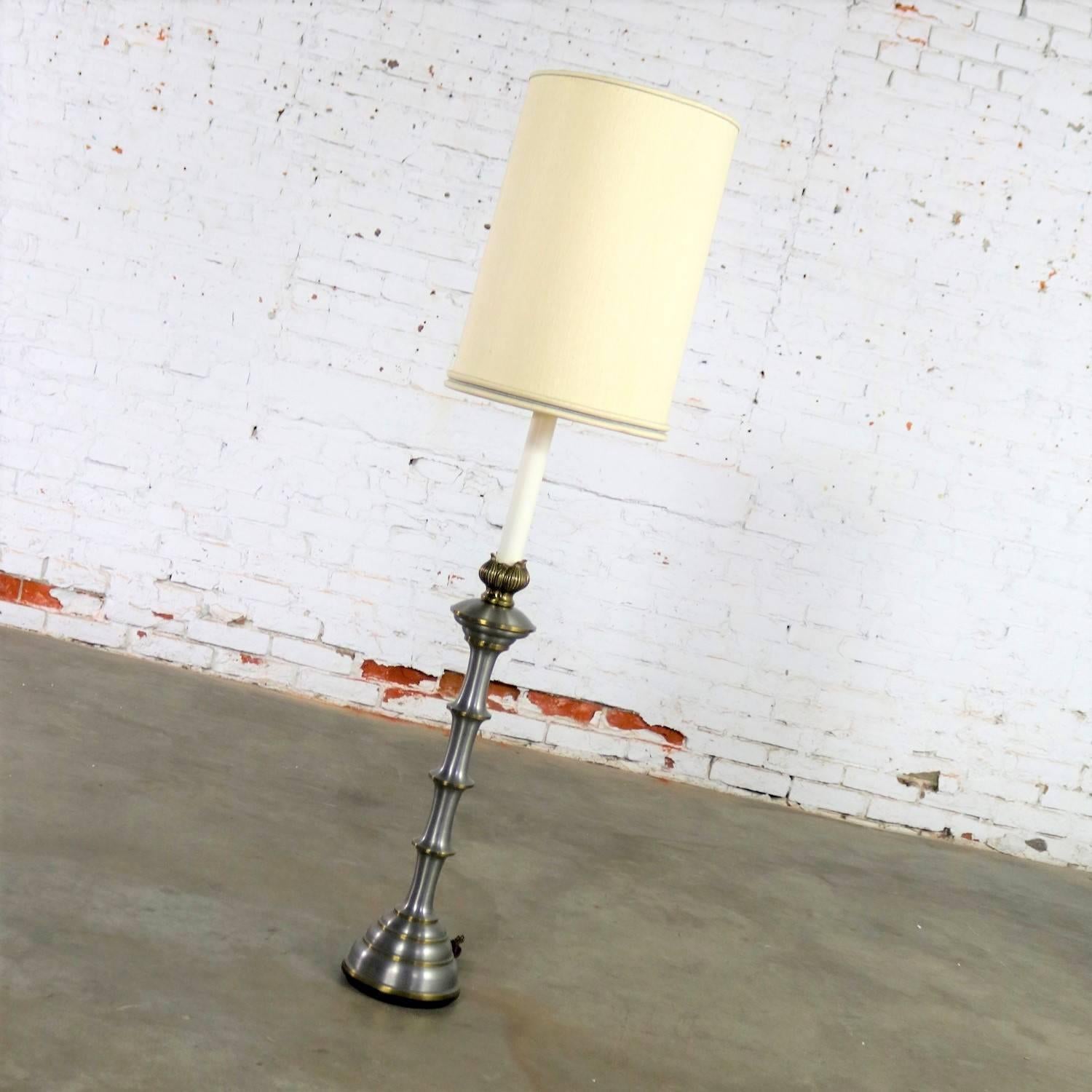 Handsome and versatile Stiffel lamp comprised of brass and brushed stainless steel. It can be used as an over-scaled table lamp or a lower than usual floor lamp. It is in fabulous vintage condition and comes with its original existing cream tall and