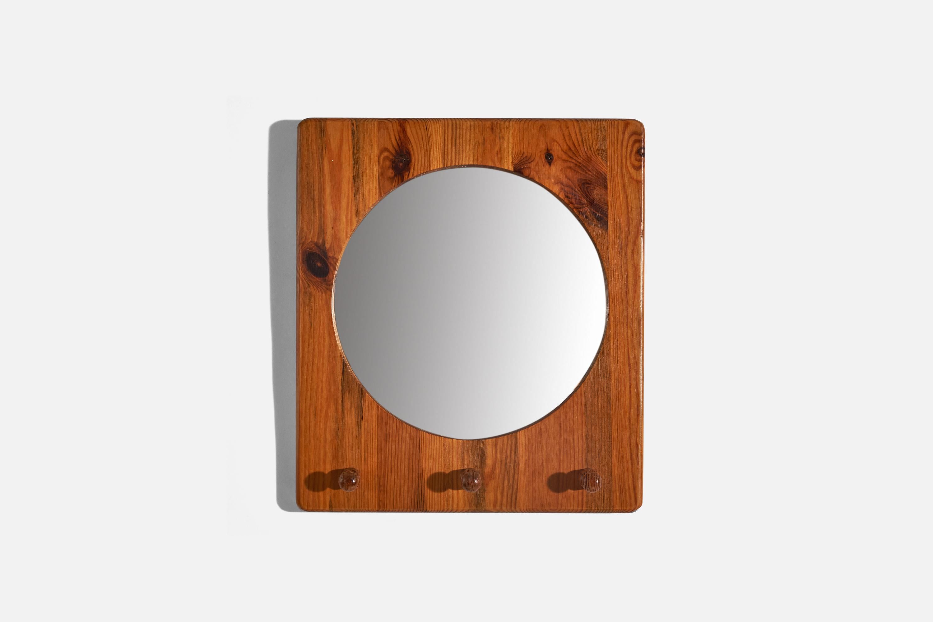 A pair of pine wall mirrors designed by Stig Johnsson and produced by his firm Smålandsslöjd, Värnamo, Sweden, 1970s.