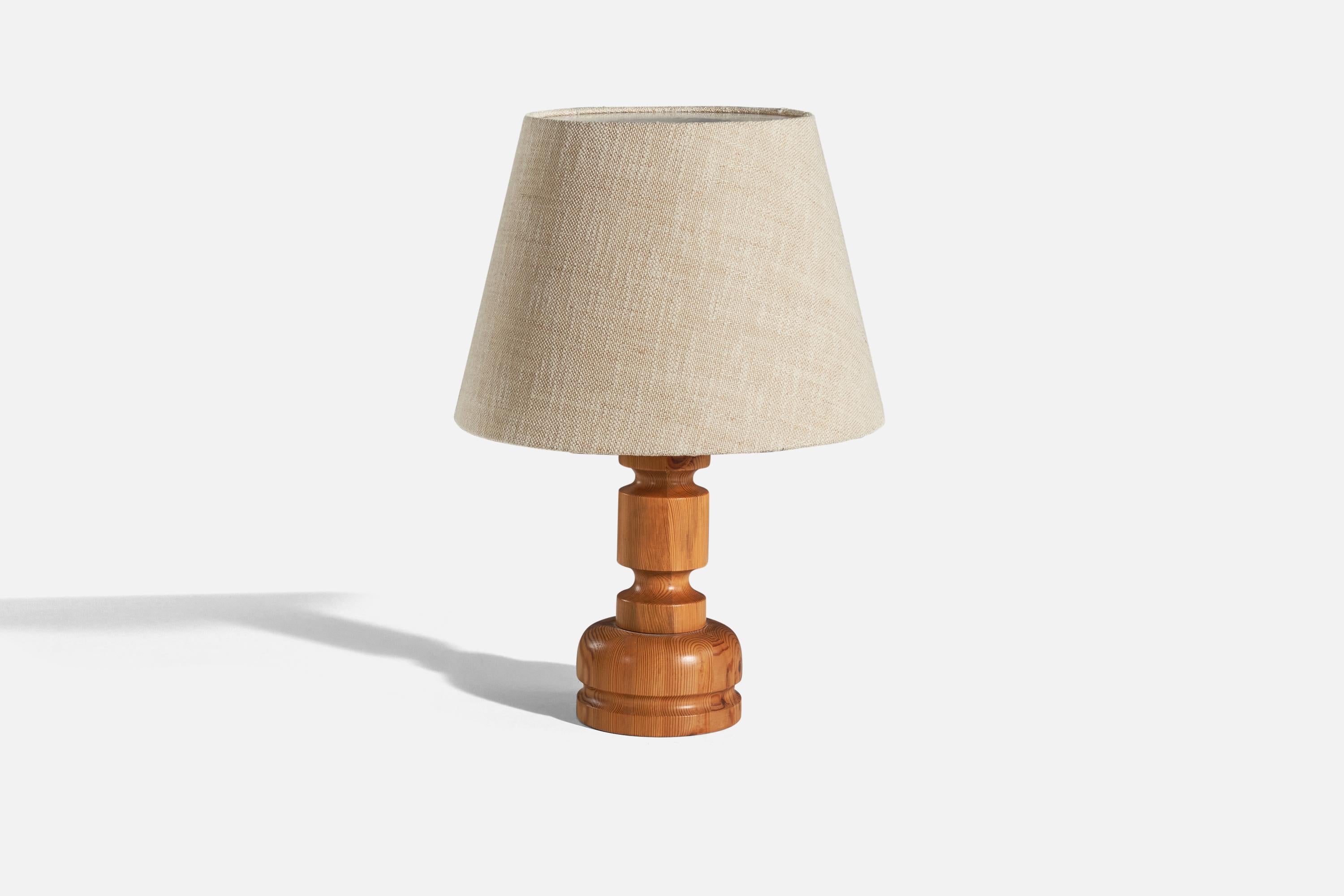 A pine and fabric table lamp designed by Stig Johnsson and produced by Smålandsslöjd in Sweden, c. 1970s.

Sold with lampshade. 
Dimensions of Lamp (inches) : 14.06 x 6.12 x 6.12 (H x W x D)
Dimensions of Shade (inches) : 10.5 x 16 x 11.5 (T x B