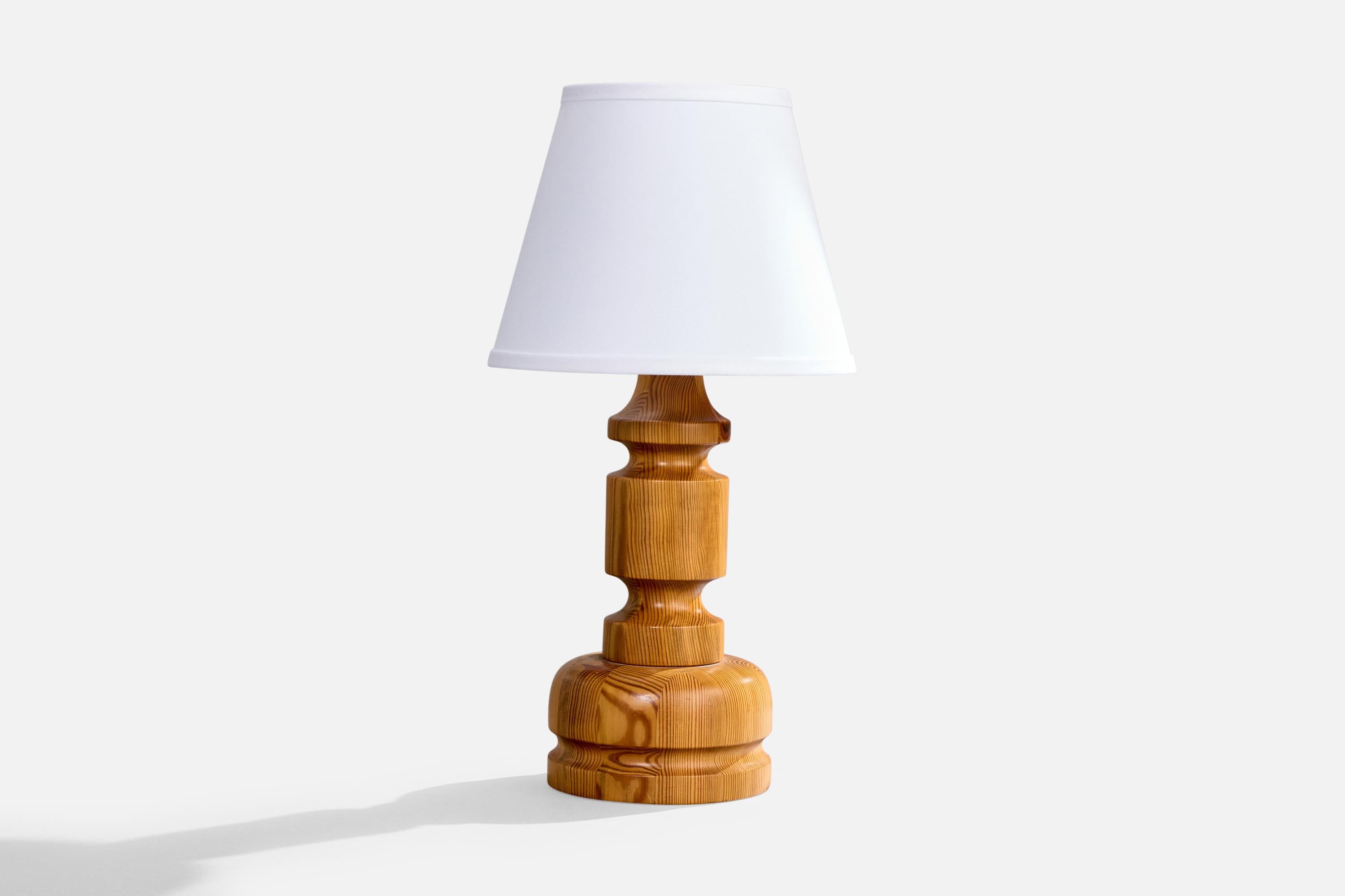 A pine table lamp designed by Stig Johnsson and produced by Smålandsslöjd, Sweden, c. 1970s.

Dimensions of Lamp (inches): 14” H x 6.25” Diameter

Dimensions of Shade (inches): 6” Top Diameter x 10“ Bottom Diameter x 8” H

Dimensions of Lamp with