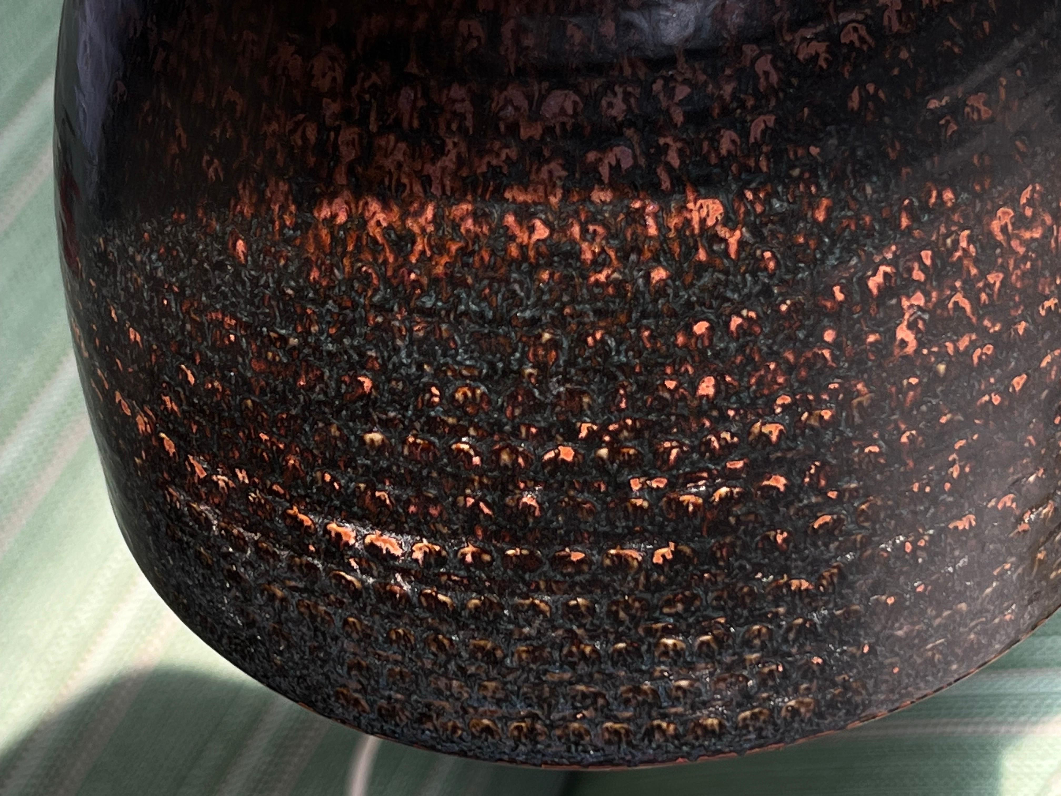 This is a very unique table lamp with the very famous Japanese glaze (tenmoku). Its a higher piece than usual. This is a real lamp not a vase that was transformed later. You can see the glaze around the cable hole on the detail picture. A signature