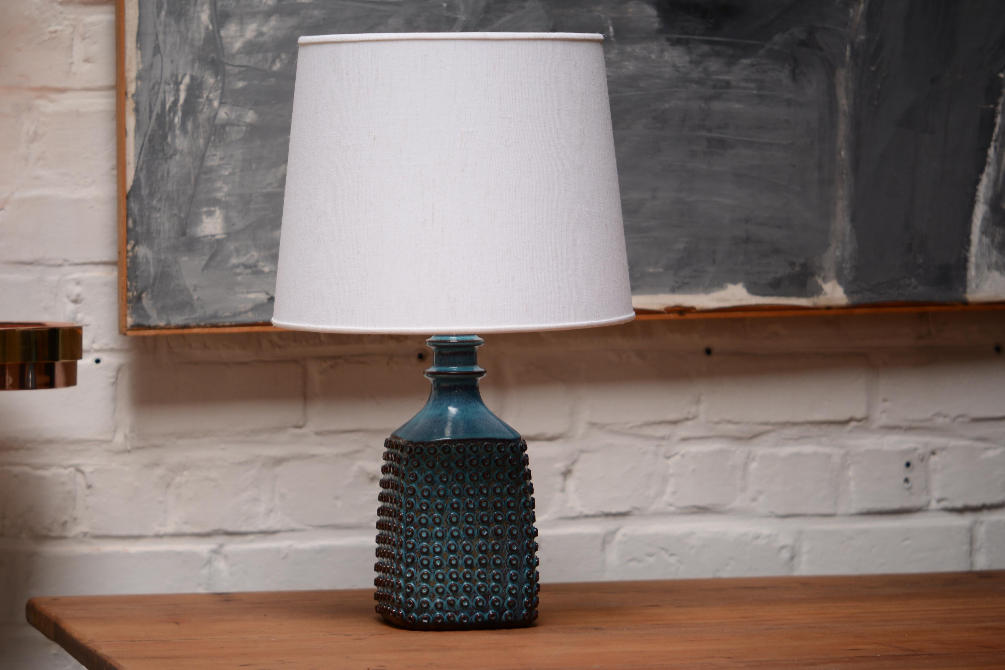 This is a very unique table lamp with the very famous blue glazed. Its a higher piece than usual. This is a real lamp not a vase that was transformed. You can see the glaze around the cable hole on the detail picture.

The lamp received a new
