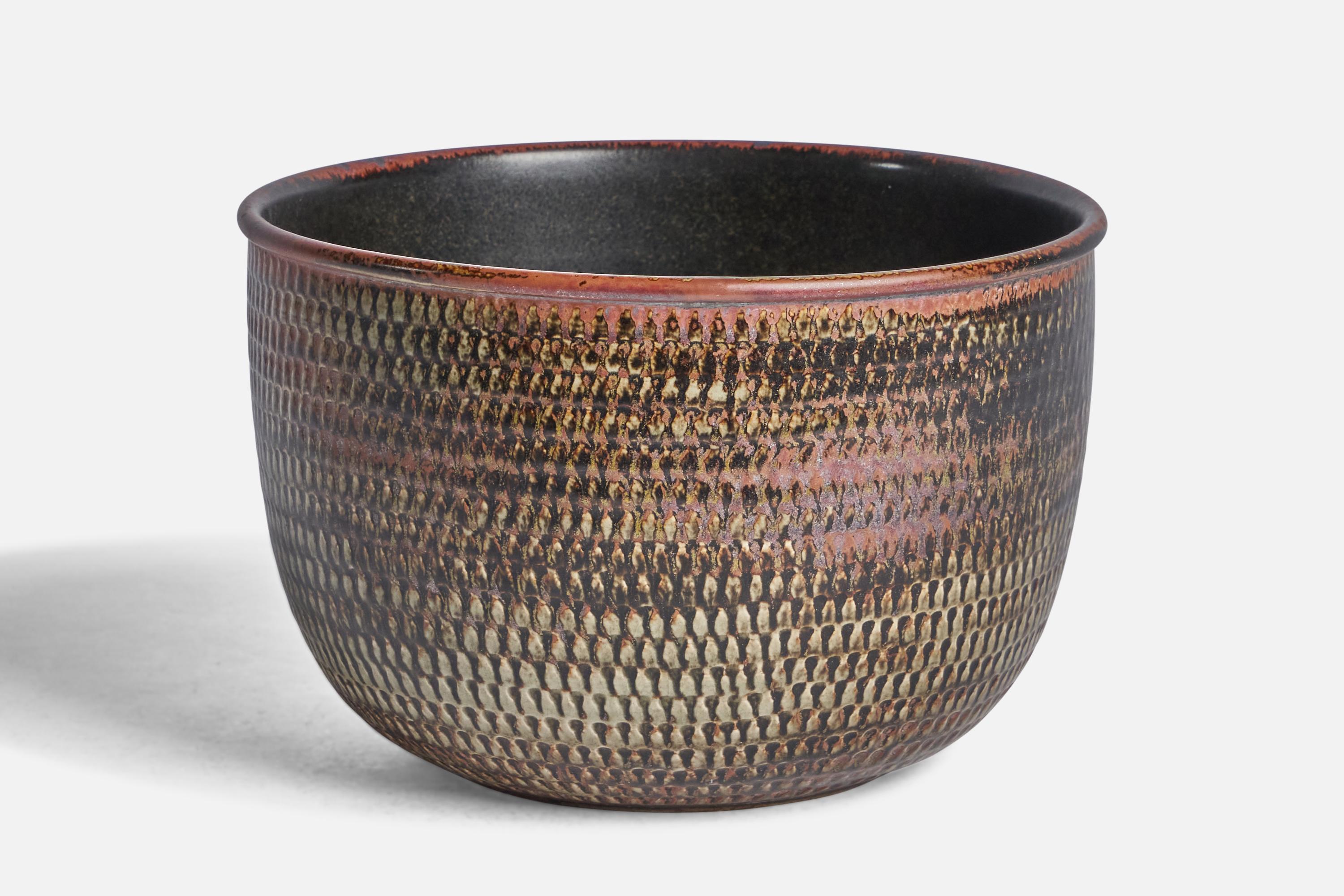 A red, black and beige-glazed incised stoneware bowl designed by Stig Lindberg and produced by Gustavsberg, Sweden, c. 1950s.